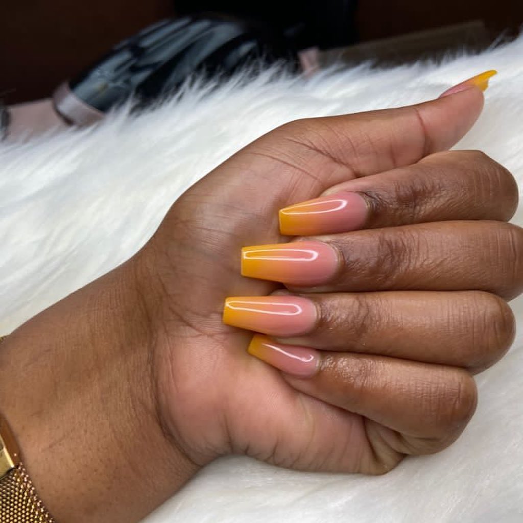 Square orange ombré manicures such as this one will look the best for the summer season.