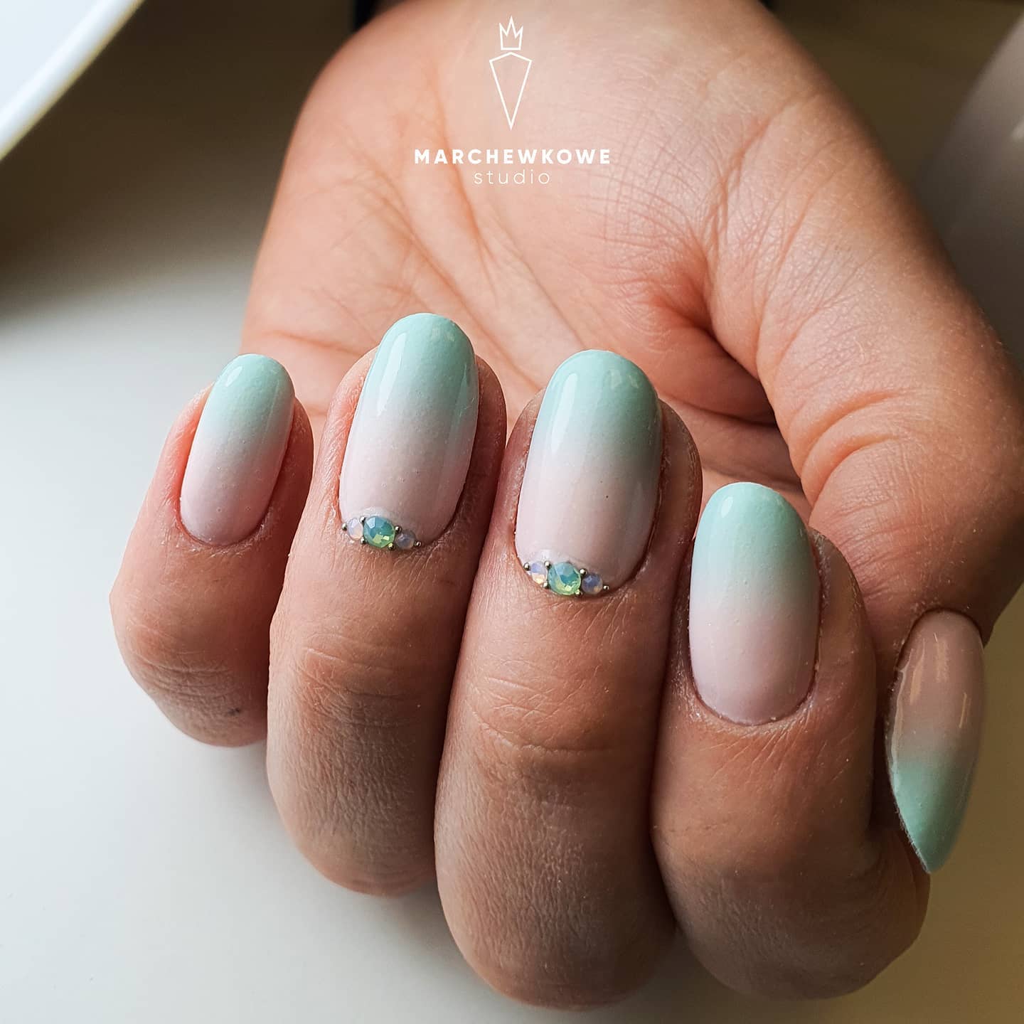 Light green but with a gemstone pop, this manicure is for women who enjoy pastel shades and elegant ideas.