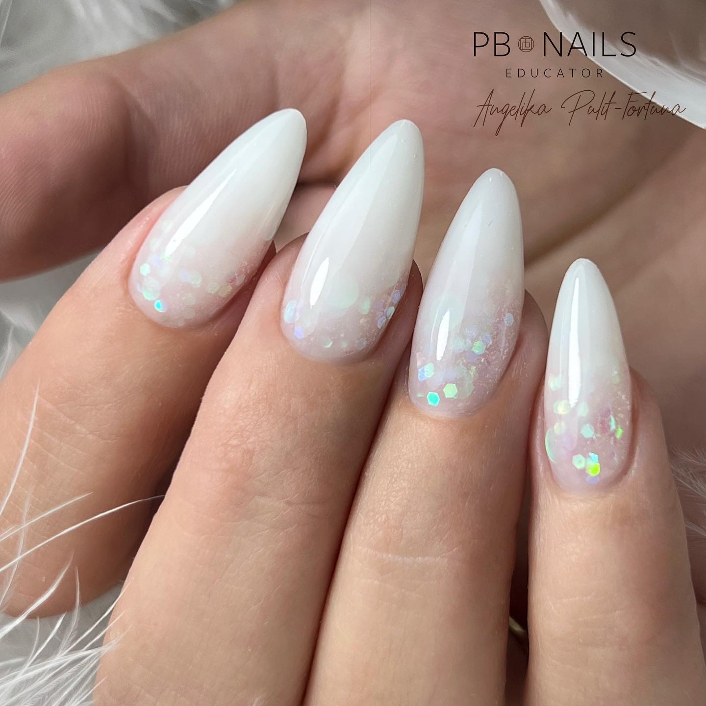 Long almond nails such as these nails will work the best for younger women or brides to be. Fancy a pop of shine and color to your white base?