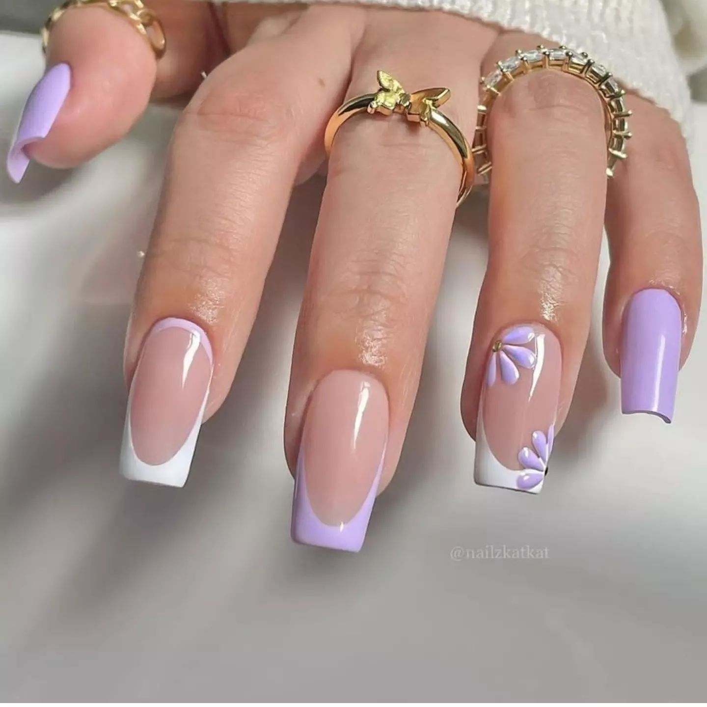 These are the cutest lilac and white French nails for the spring season! Women who enjoy flowers and soft glam ideas will fancy this mani the best! Heads up since it will take a skilled nail technician to achieve this outcome.
