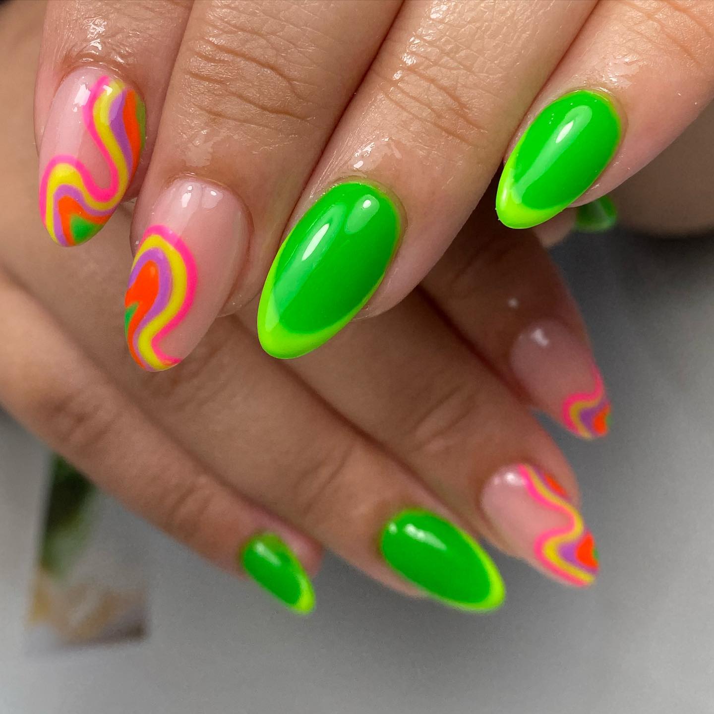 Hot neon rainbow nails such as these will attract a ton of attention and looks everywhere you go.
