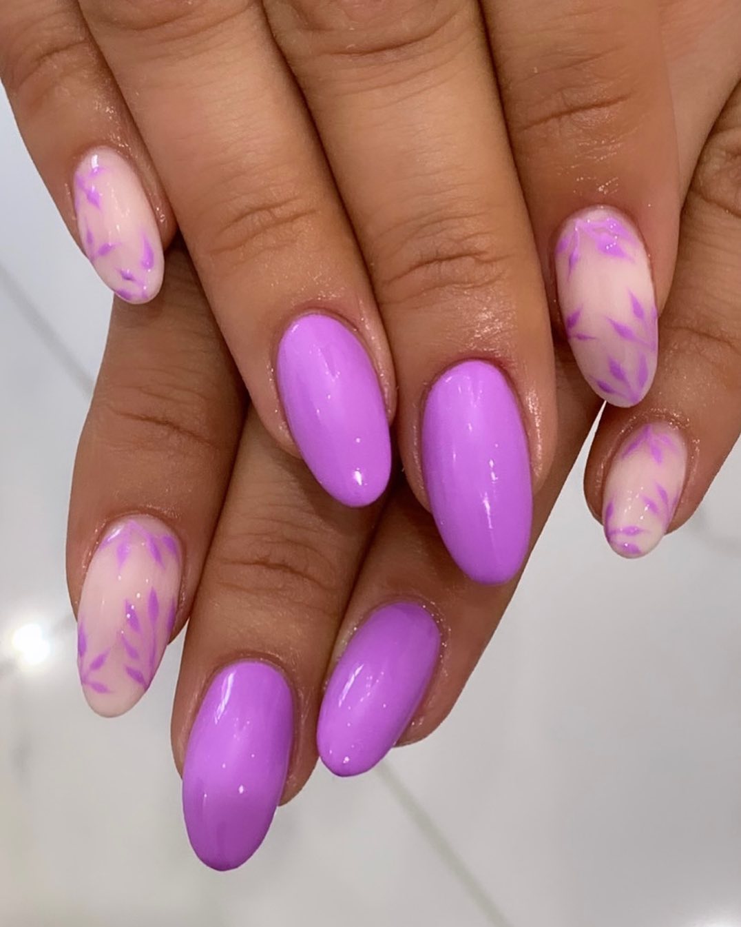 Purple almond nails such as these will look the prettiest on younger women who enjoy pastel colors.