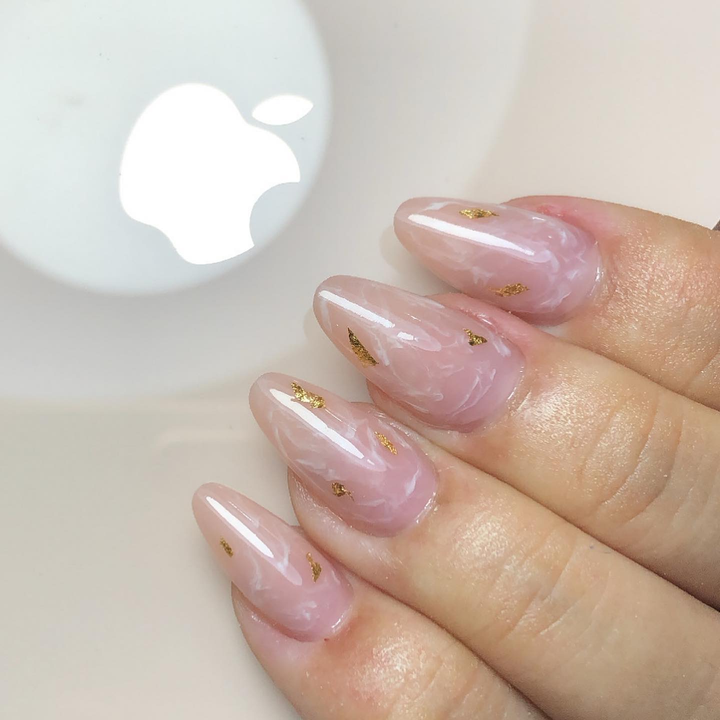 Light pink almond nails such as these and this pop of gold glitter will look the best on women who like romantic ideas.