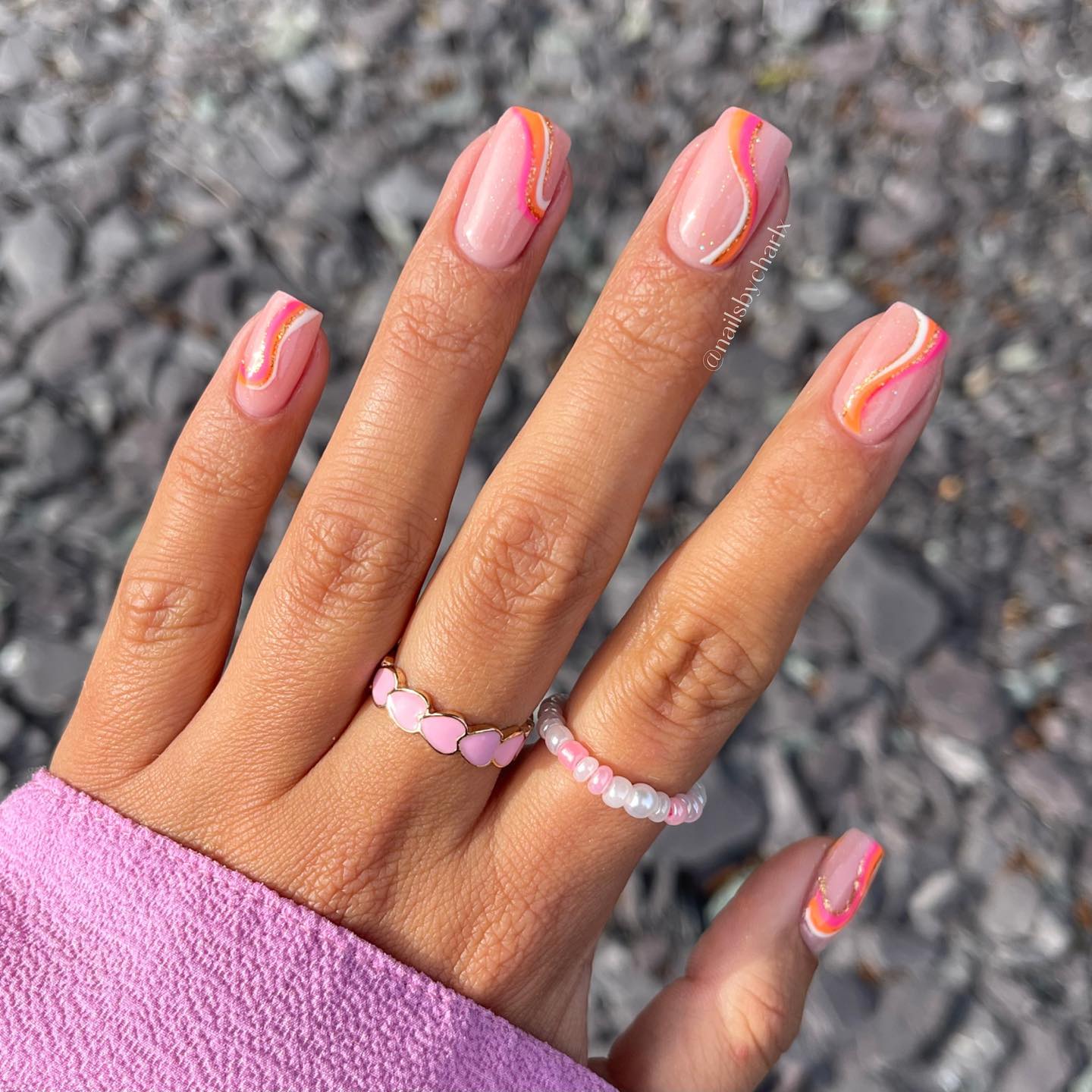Short pink and cute with a pop of orange, this is the ultimate summer mani!