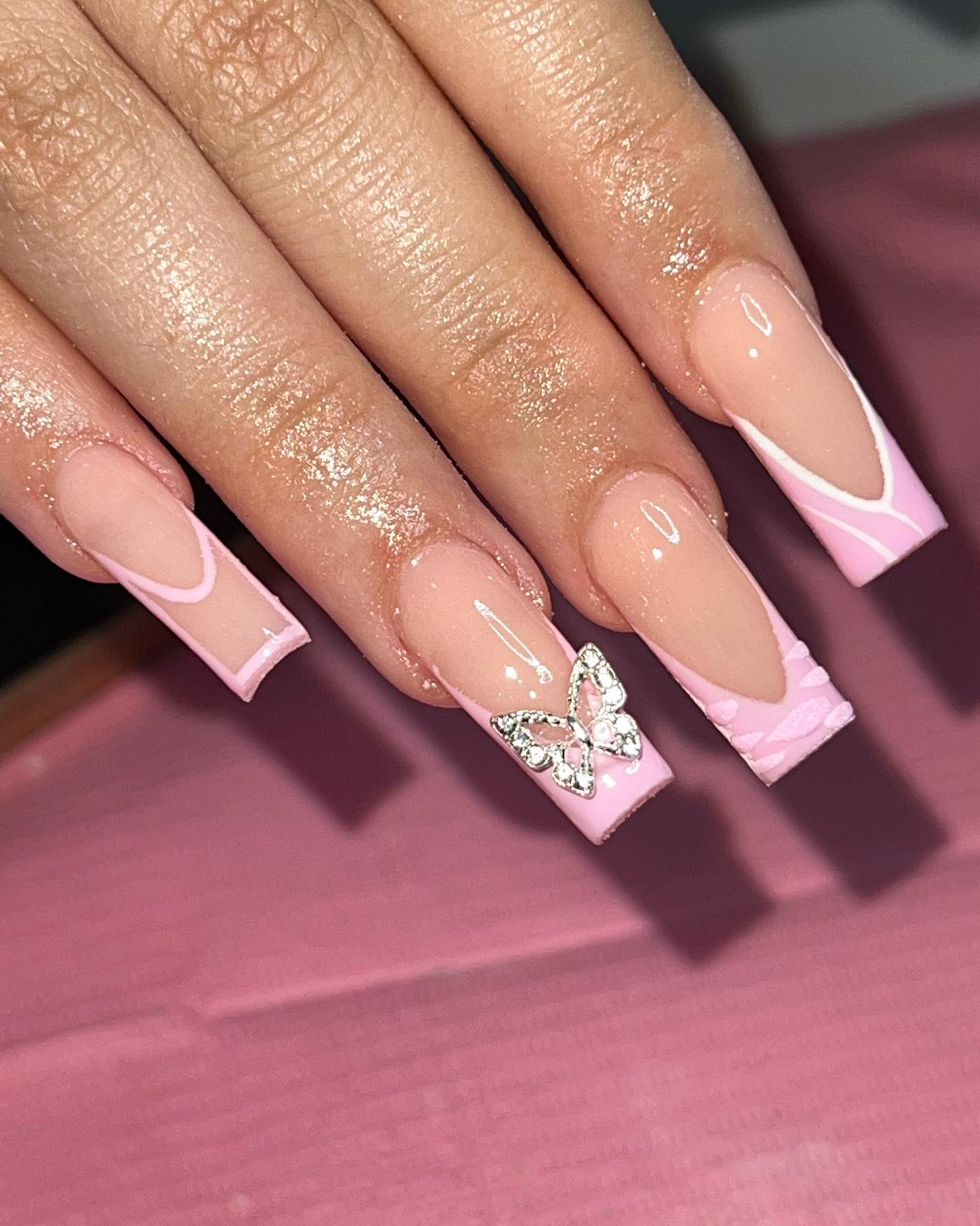 True ultimate Barbie pink manicure! This type of French design with a cool and cute little butterfly gemstone design will look perfect on women who are in their twenties, and are all about that poppy TikTok trend vibe!