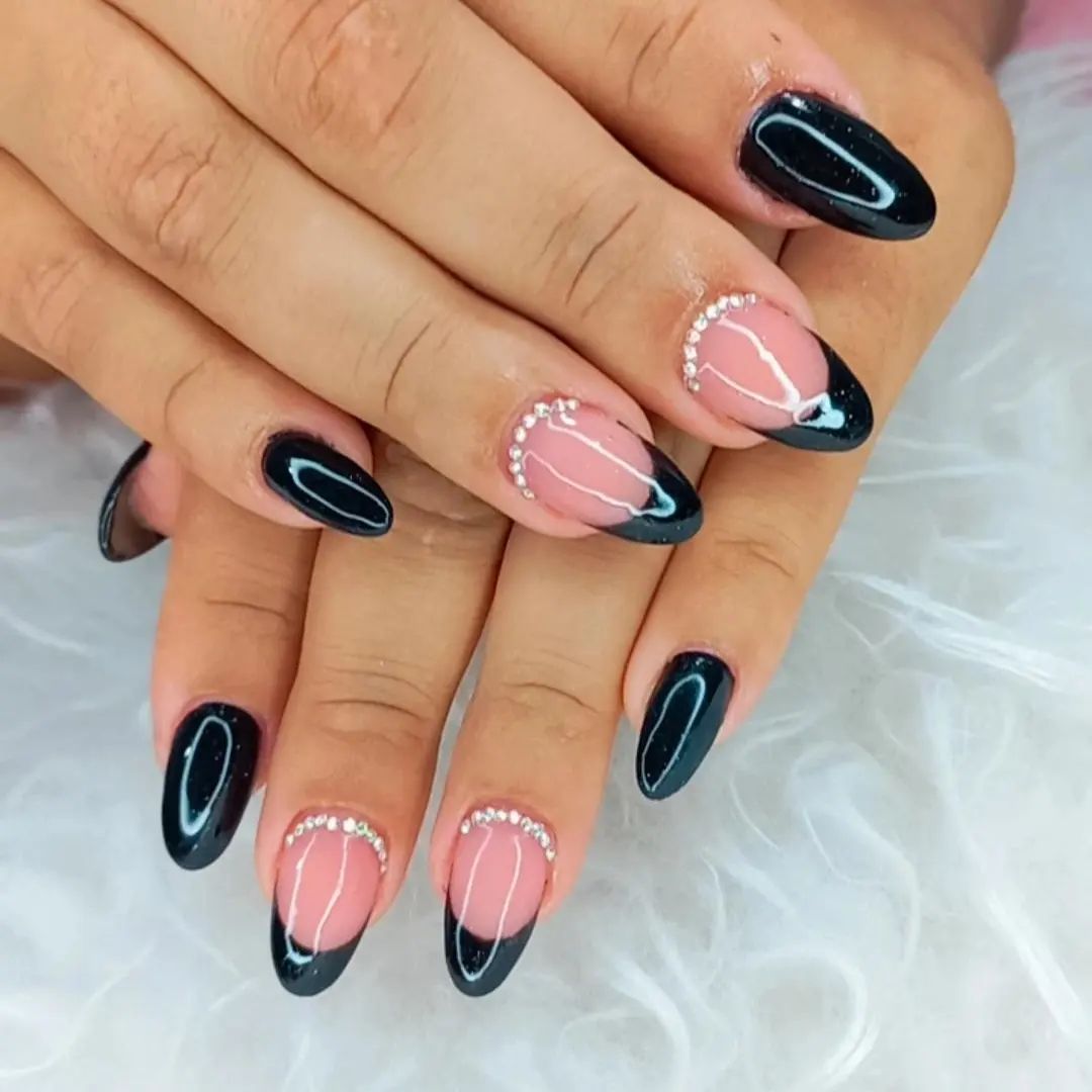 Cool black almond French manicure that is cute and sexy at the same time. Finish off the look by adding a ton of glossy finishing coat.