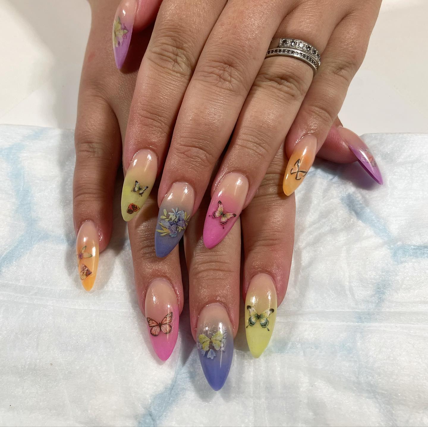 On top of your beautiful ombre nails, why not adding colorful butterfly stickers? These stickers go with colorful nails.