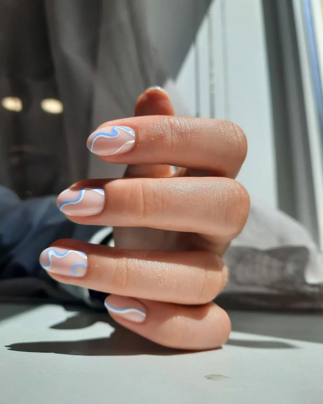 Swirl nails are so popular, aren't they? You don't need to use light blue color fully on your nails, so you can draw some blue swirls on a nude base.