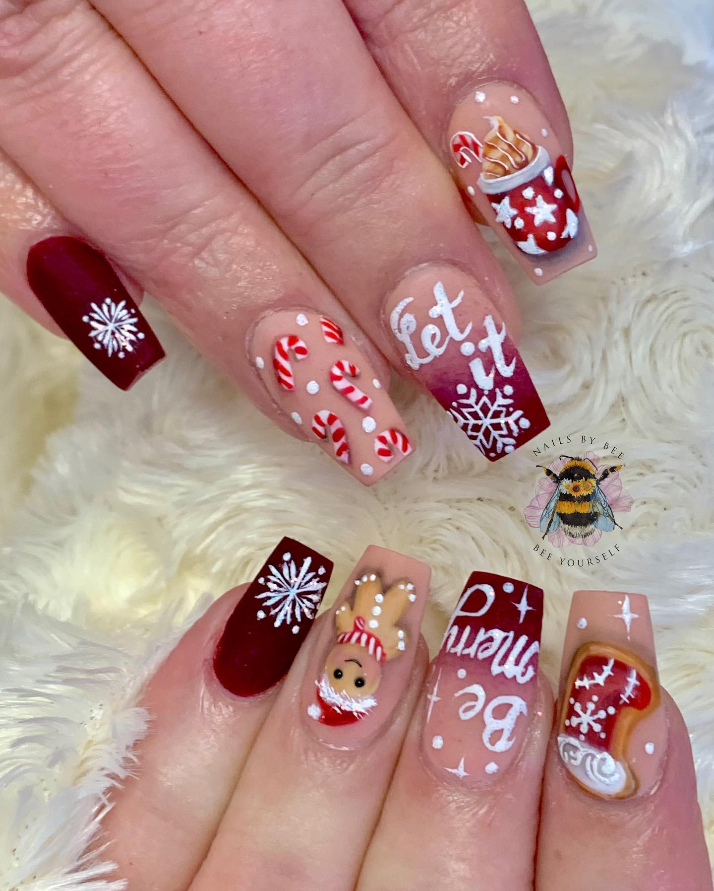 To feel the Christmas to the fullest, you should definitely go for this nail design. It is full of snowflakes, candy canes, Christmas sock and candy cane.