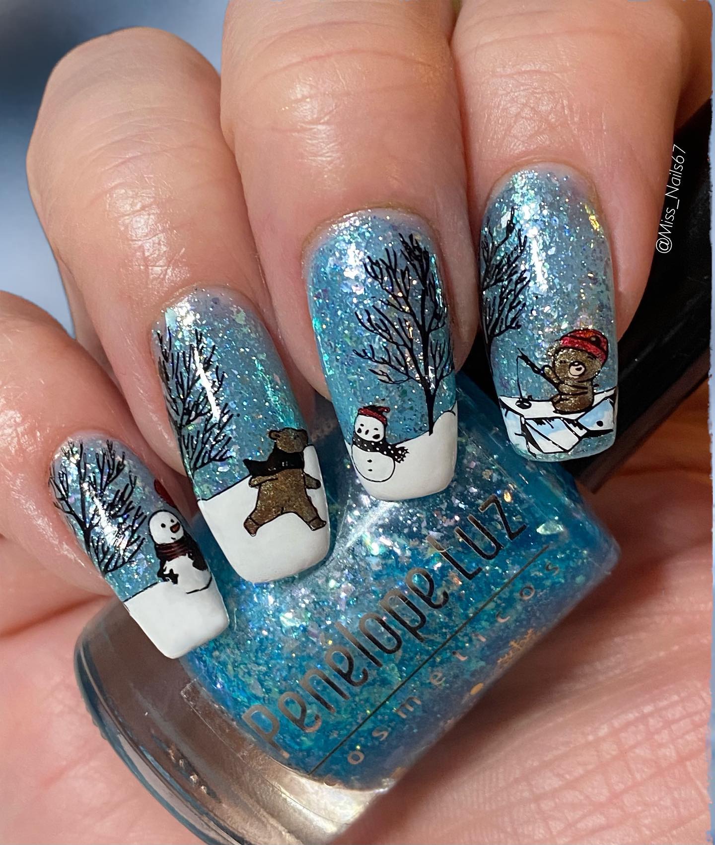 Winter nail ideas cannot be listed without a snowman. So, here is a nice one above. There are also bears in this nail design. 