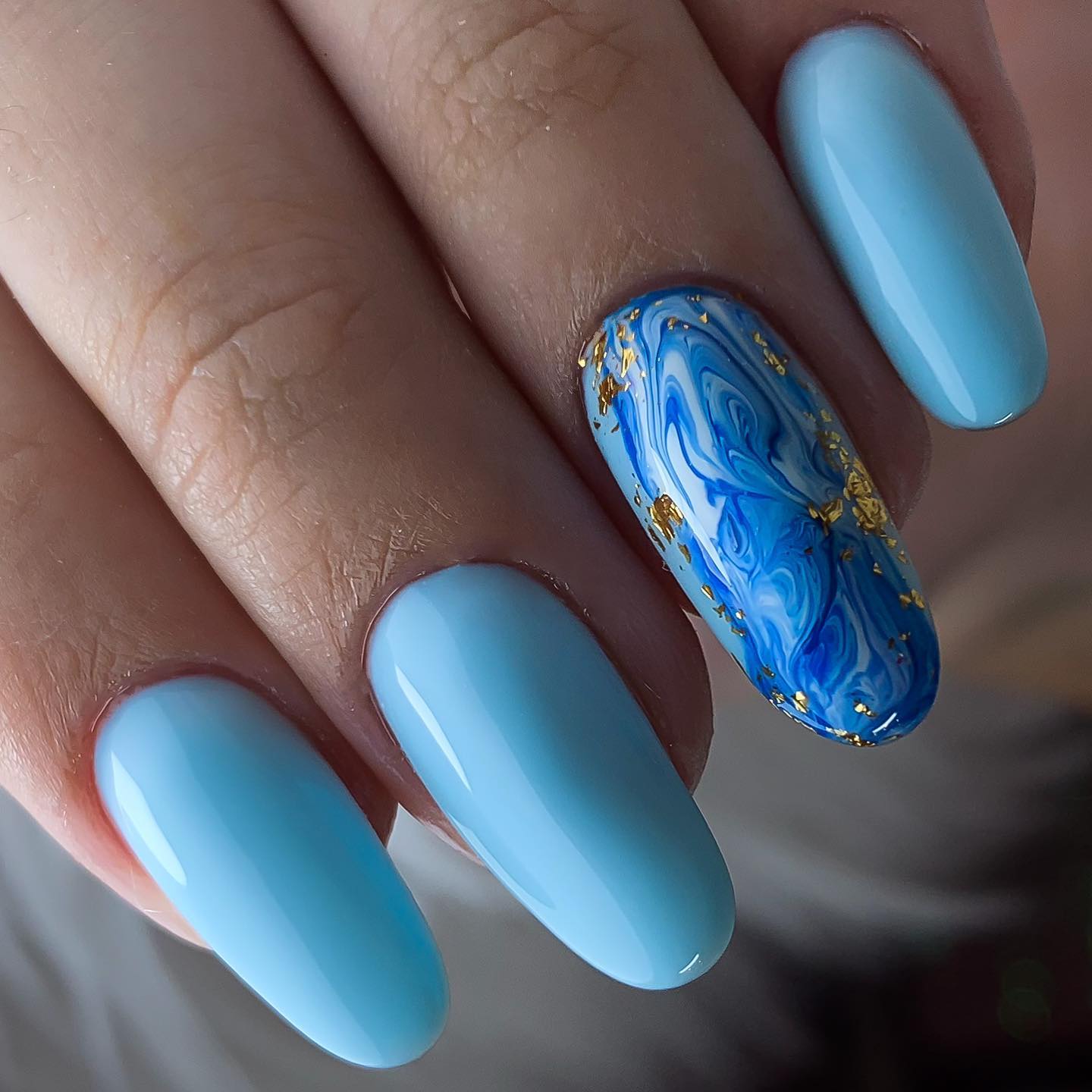 Water marbling is a nice way to take your nails to a whole different level. Dark blue color can be used to give this effect.