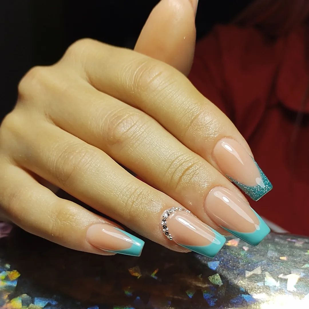 For your square nails, putting some shiny stones on top of your light blue French tips looks perfect like the example above.