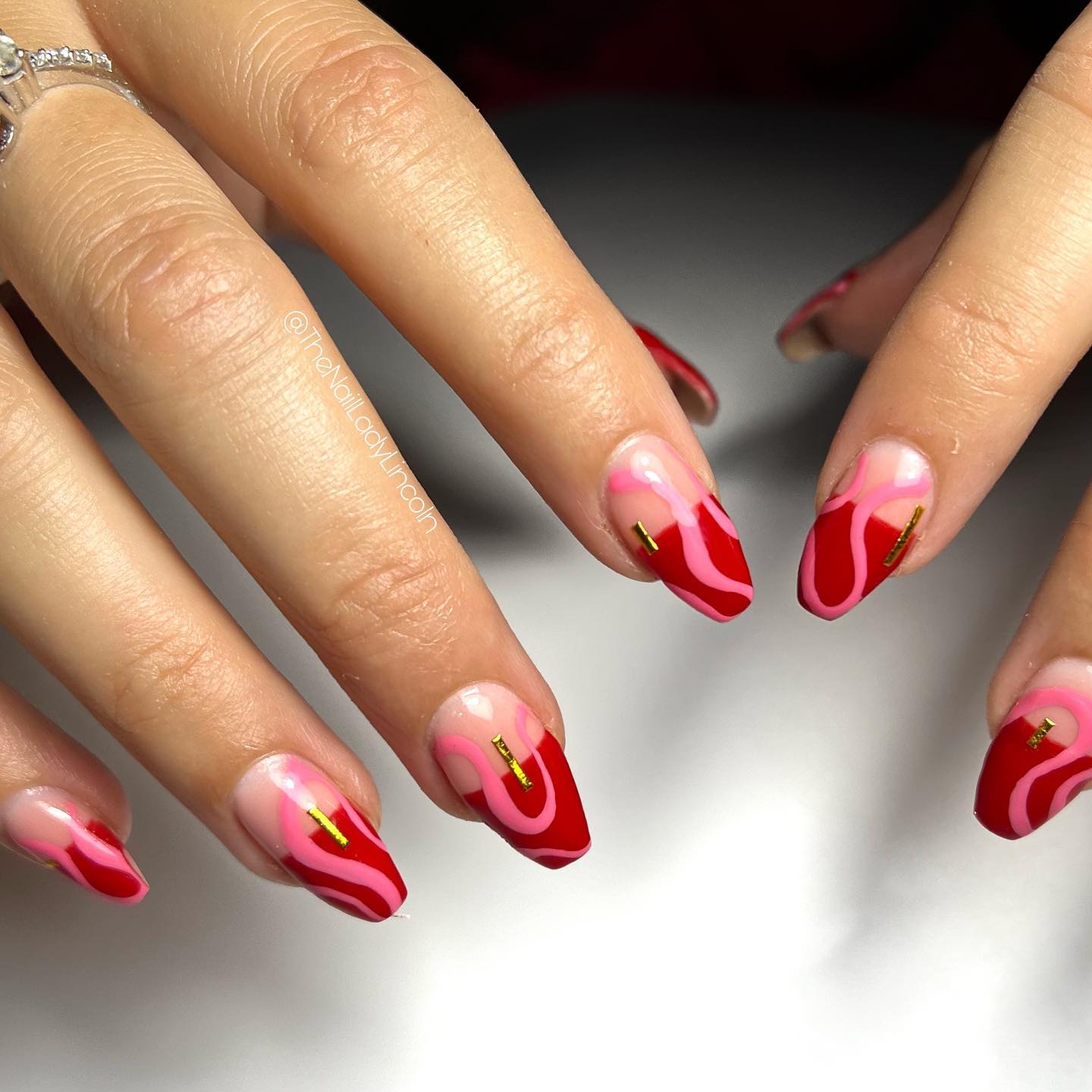 Mixing pink with red color is a good idea for most of the time. Half red nails and red lines will make you rock!