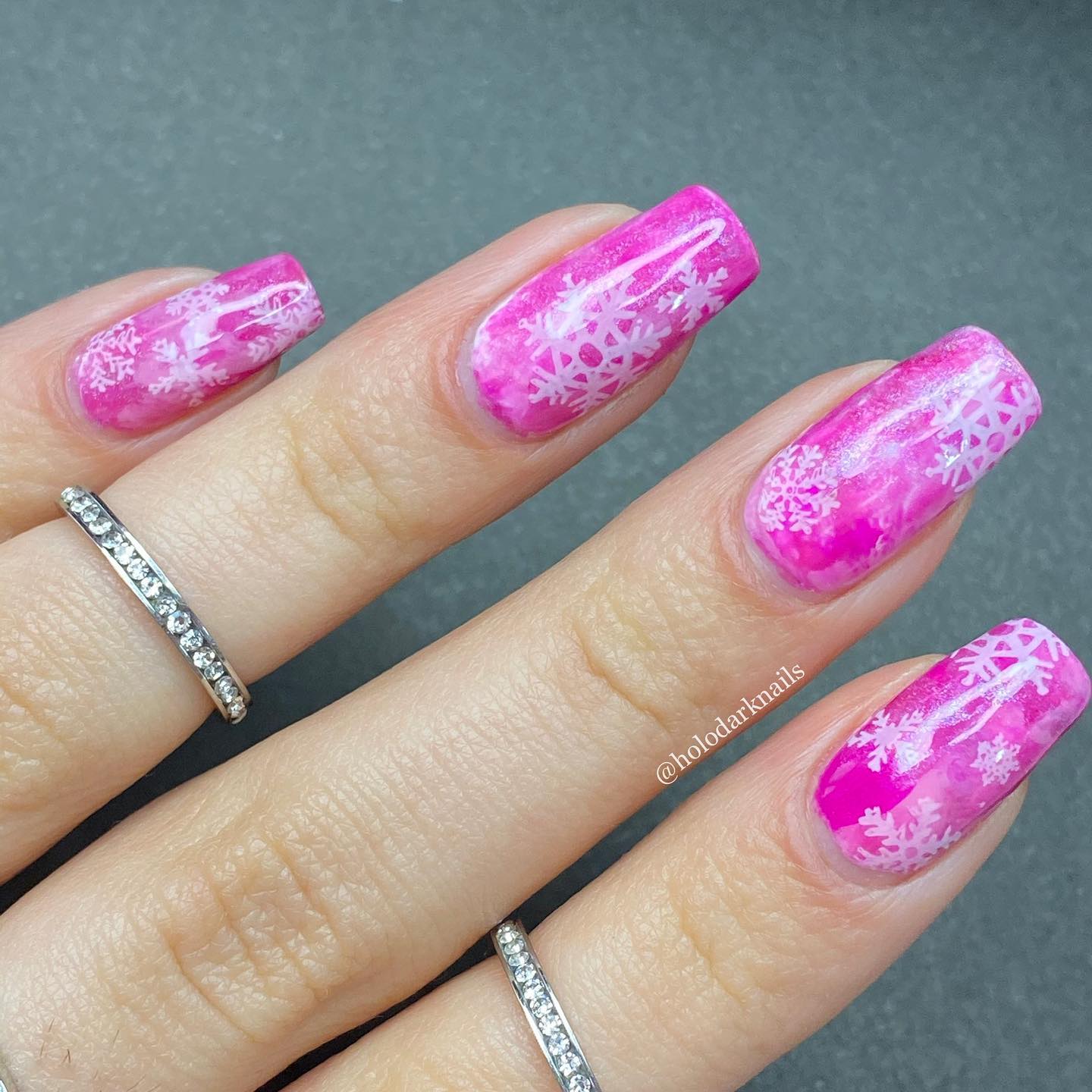 Different shapes of snowflakes on pink nails look amazing. You should combine this color with snowflakes!