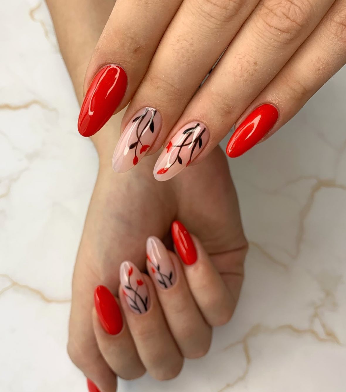 Do you want to add something nice to your nails? You can add some flowers and make your red manicure look awesome.