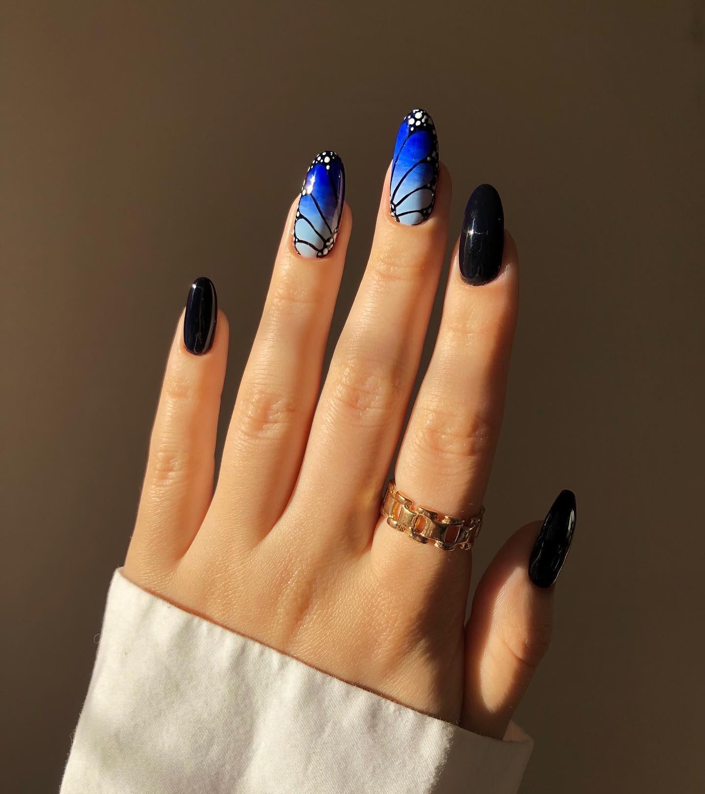 Black has always been a favorite color for nails. Have you ever tried to mix it with some blue butterflies? If not, hurry up.