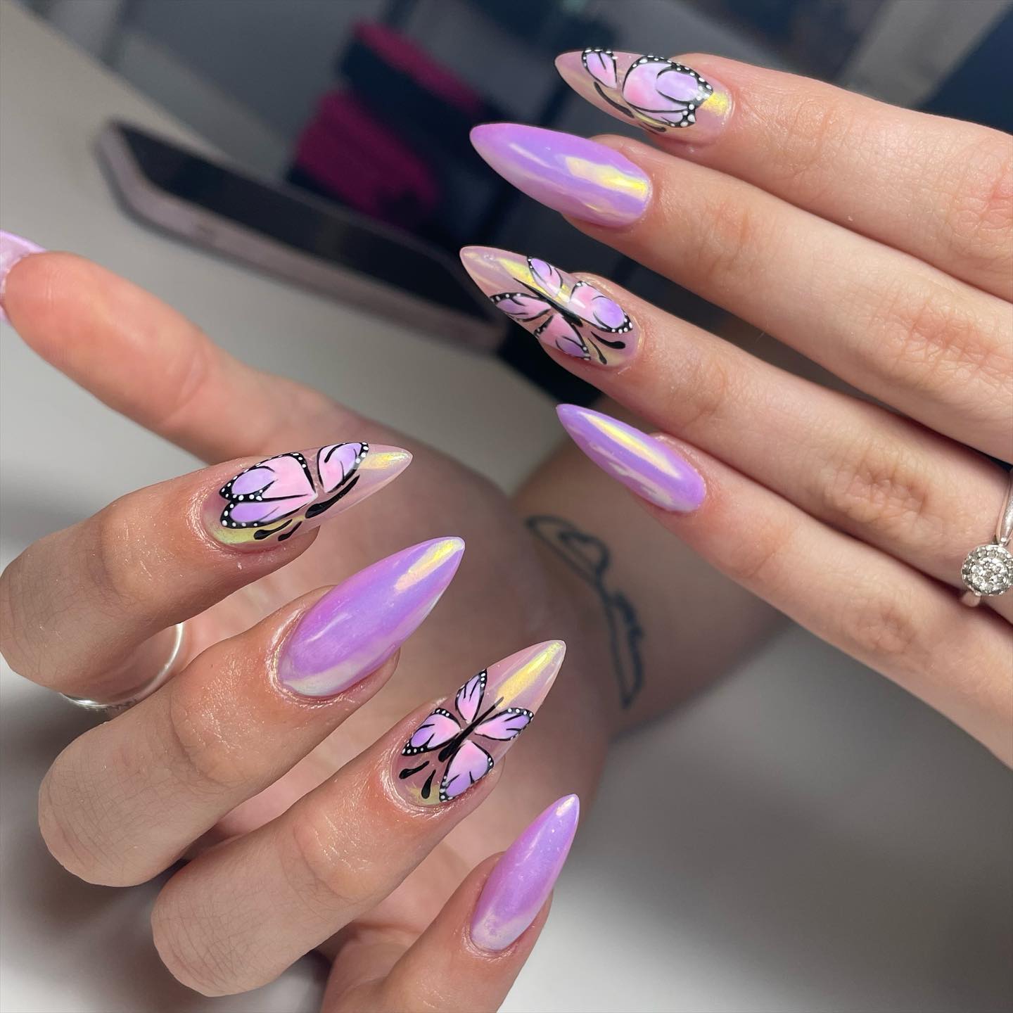 These sharp shape of nails look amazing with a shiny look. The pinky purple butterflies take these nails to a whole different level.