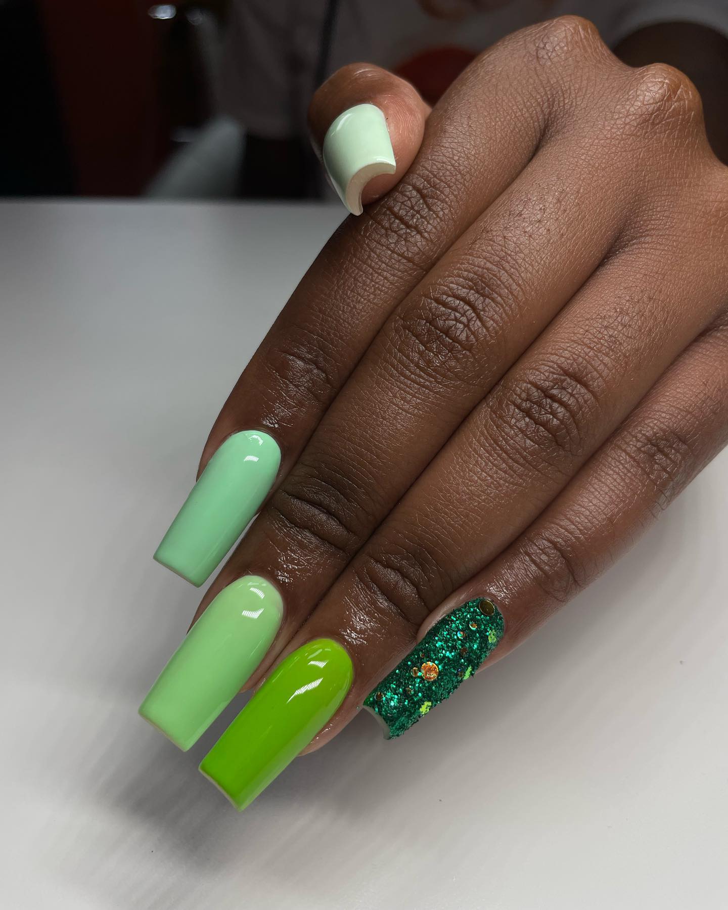 A lot of women are indecisive and you are right actually. When there are so many great options, who can choose one easily? That's why, you can use different shades of green and glittered one in your nails together.