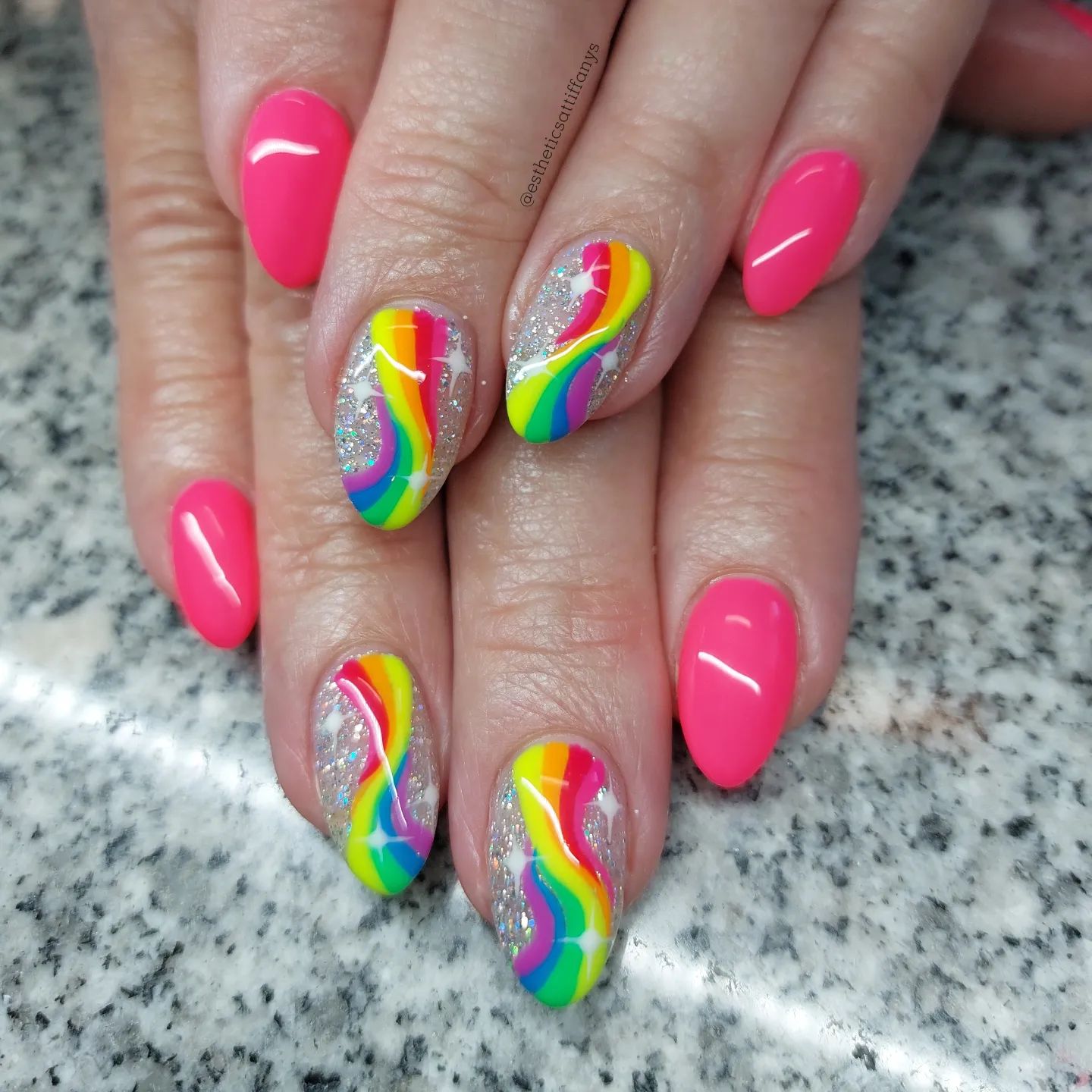 These nails look like they belong to a pinky world where unicorns live, don't they? Glittered rainbow accent nails are fabulous with pink nails.