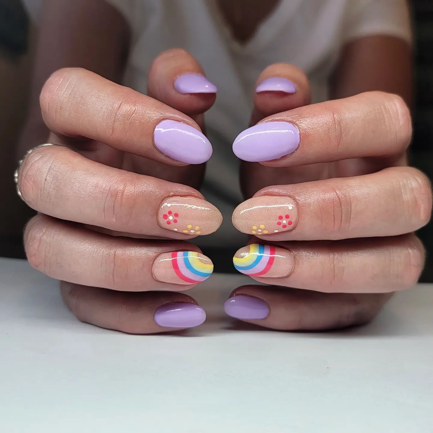 Here is an amazing nail design idea for summer. Light purple is cool for summer especially but why not having a rainbow and floral accent nails?