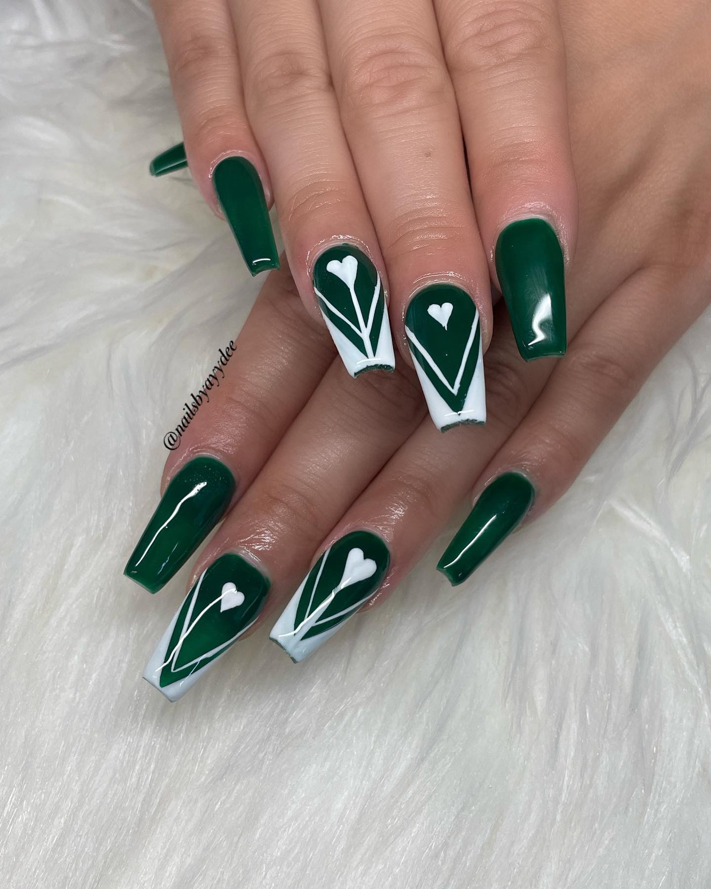 Isn't dark green a classy color? With this classy color, you can make your nails look more amazing by using white nail art.