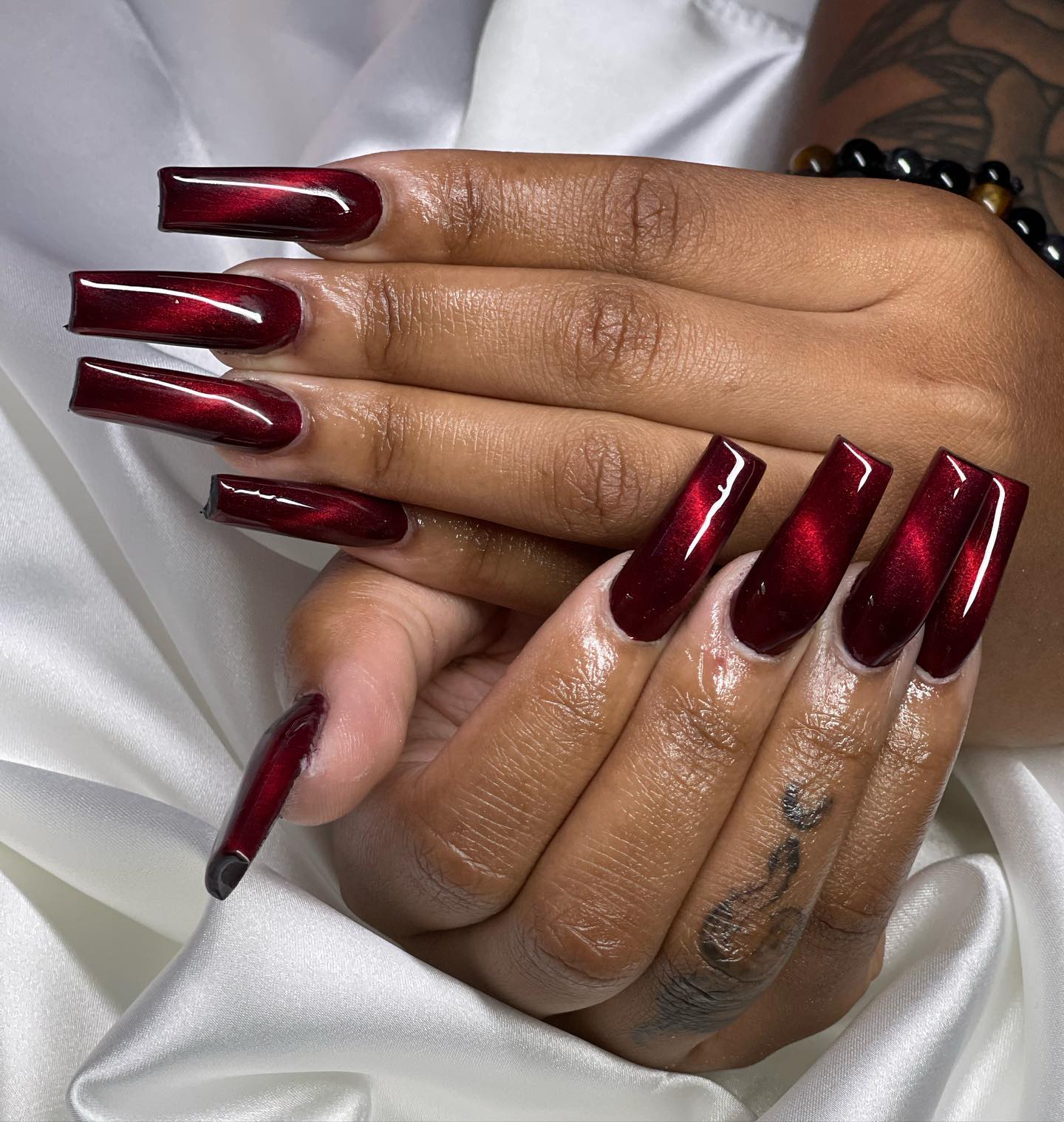 Clared red is one of the sexiest nail colors, for sure. On your long square clared red nails, bright red cat eye nail art can be used to take your nails to a different level.