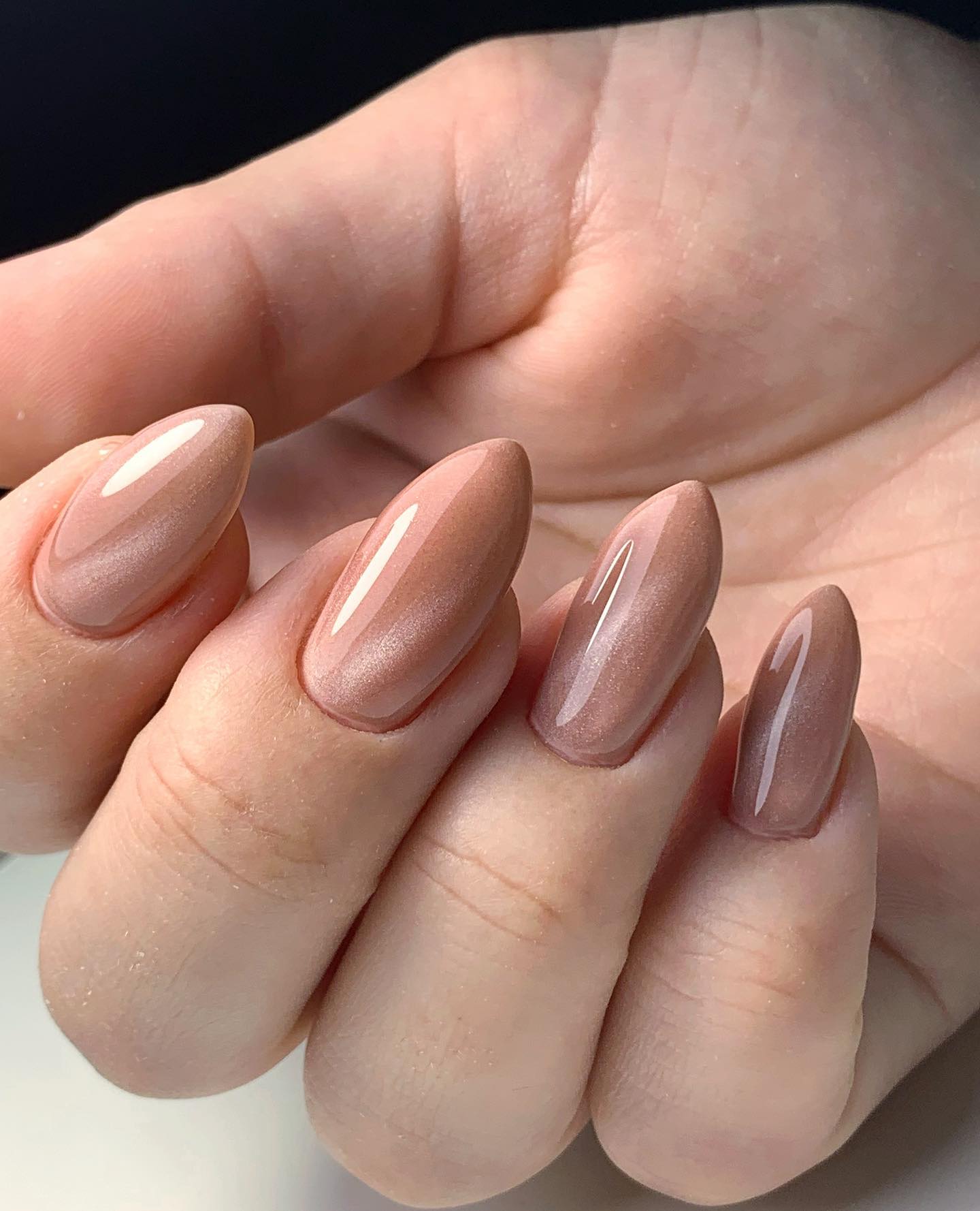 Nude nail polish offers a plain and chic look for everyone. If you want to add your style on your nude nails, you can have a shiny cat eye nail art.