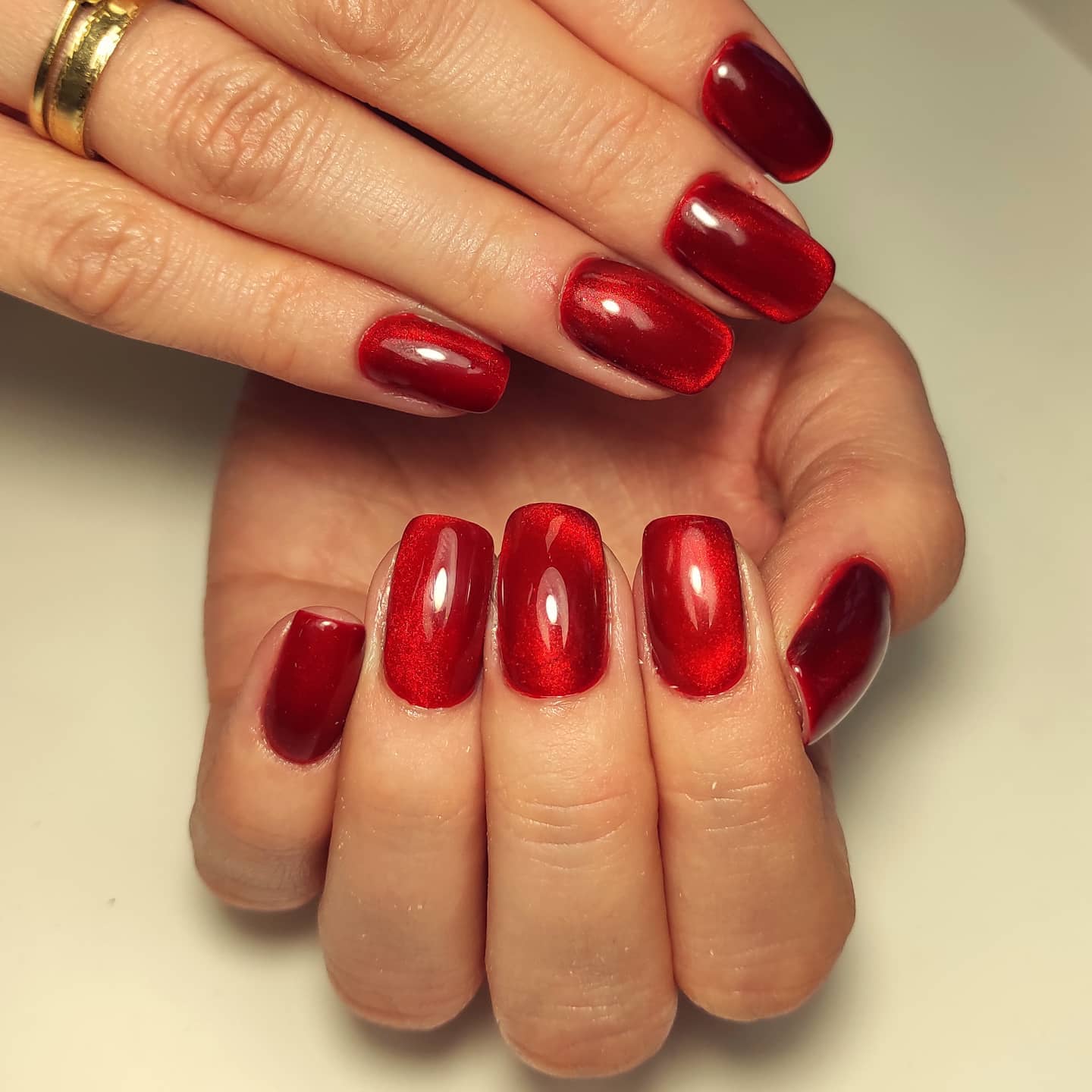 Red is everyone's favourite color, isn't it? Well, this time, you should try red nails with cat eye nail art. This design makes your nails look like dimensional.