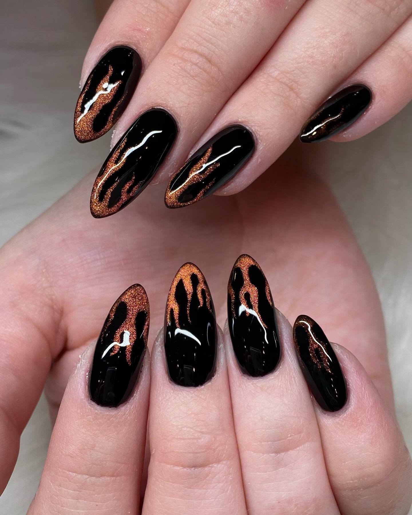 You don't need to cover up your nails with cat eyes. Instead, you can have this nail art in different shapes. The one above is a great example of it since aurora flames are used on tips.