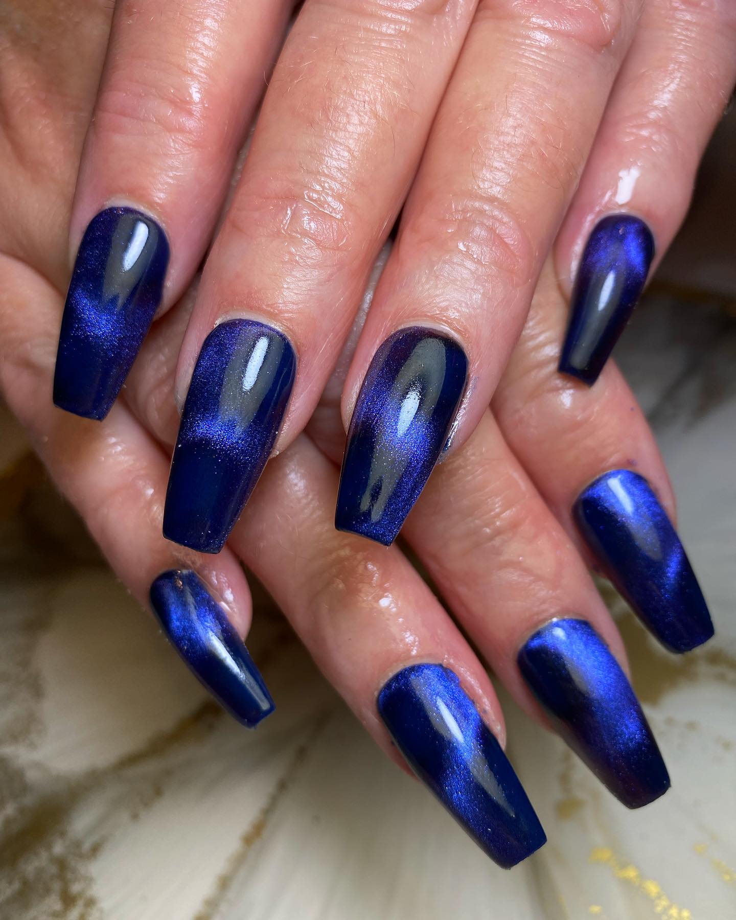 Dark blue base with a lighter blue cat eye nail design is a perfect idea. To feel the sky to the fullest, you should definitely try this out.
