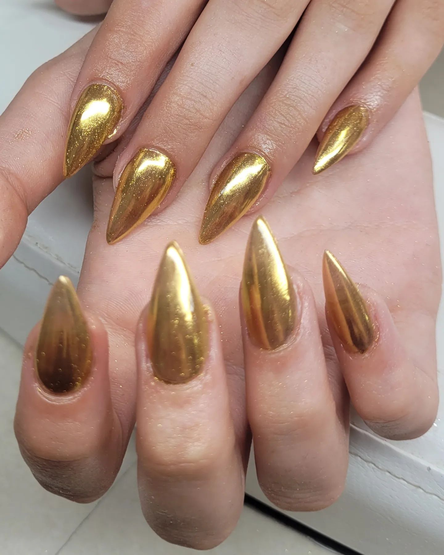Gold provides a rich look, doesn't it? If you agree on that, apply this gold chrome nail polish for your next manicure.