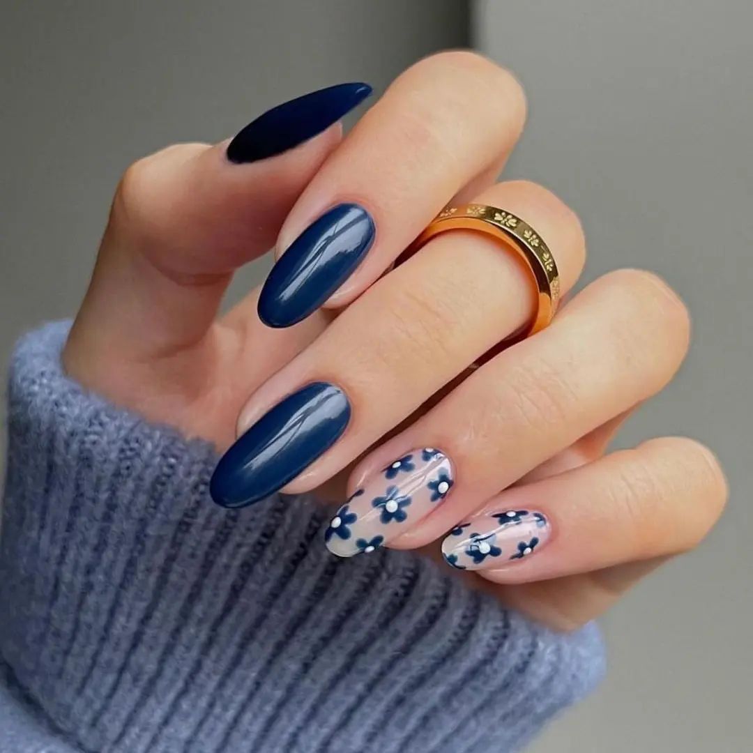 This shade of dark blue is unique to stand on its own. For your ring and pinky fingers, you can wear blue daisies on a transparent base.