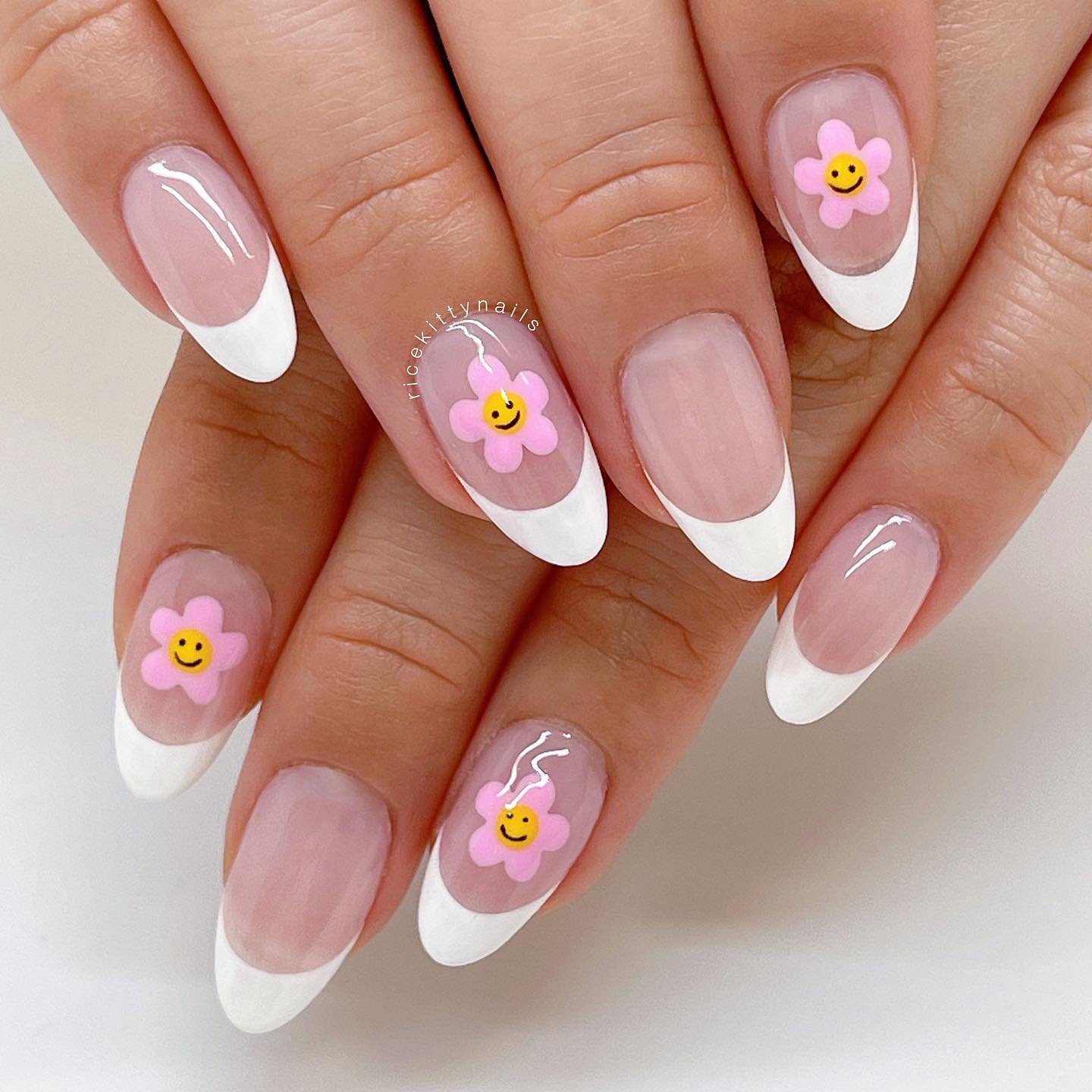 Having a cute daisy nail art and adding a smiley in the middle of each daisy rock! If you want to achieve a cute and cool look, this is definitely for you.