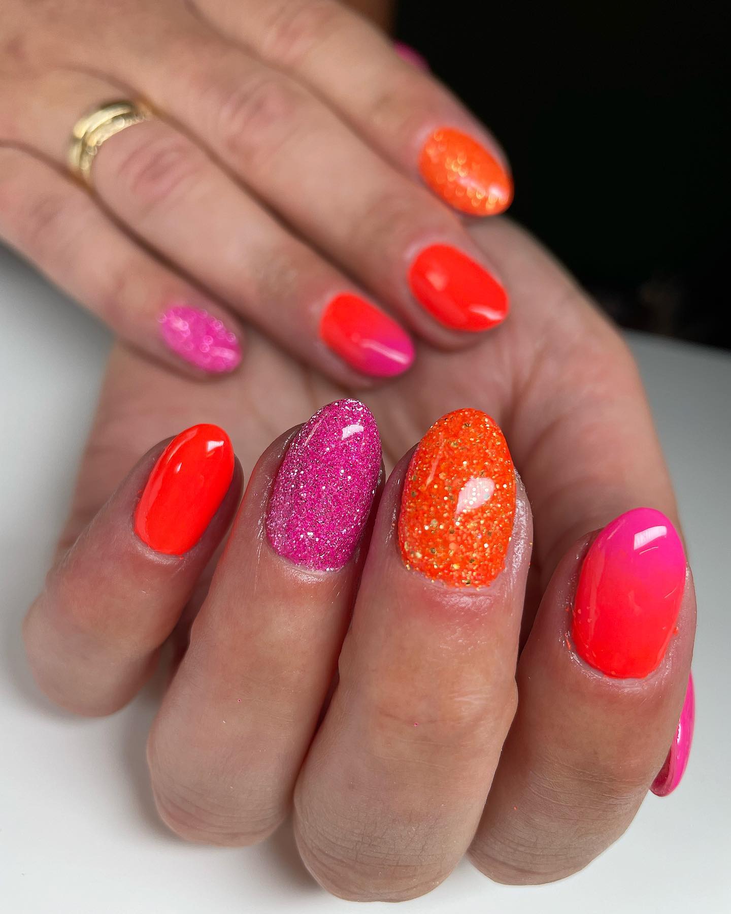 Bright orange and pink colors represent the warmth to its fullest. To make your nails shinier, you can use a glittered transparent nail polish on them.