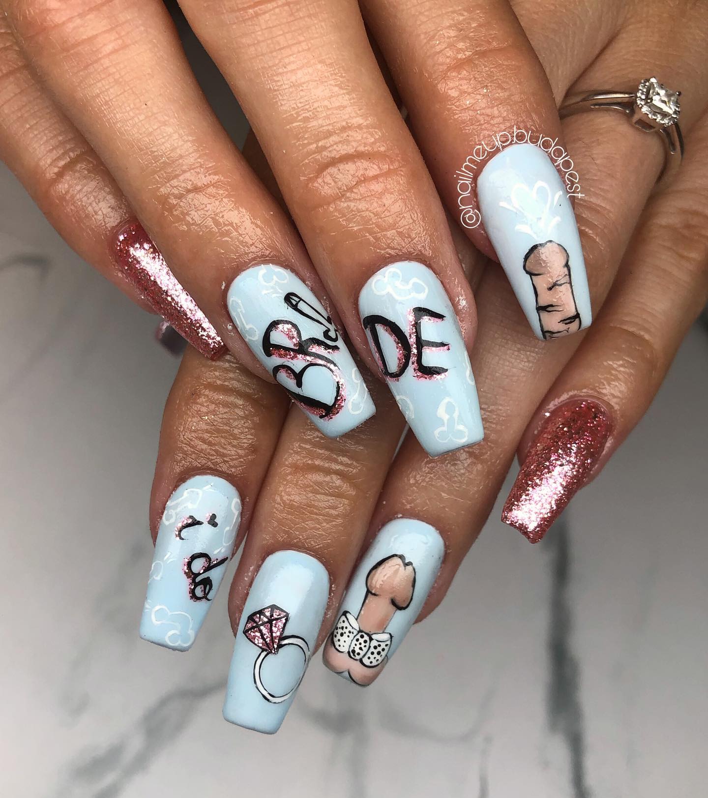 In order to have fun with your nails in your bachelorette party, why don't you apply a penis nail art that is full of wedding rings and some other things?