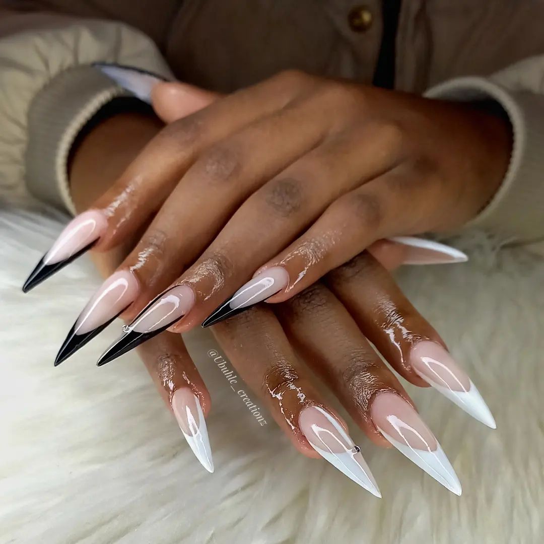 Black and white colors are one of the classics and there is no doubt that they go with together so well. You can show this perfection with your long stiletto nails.