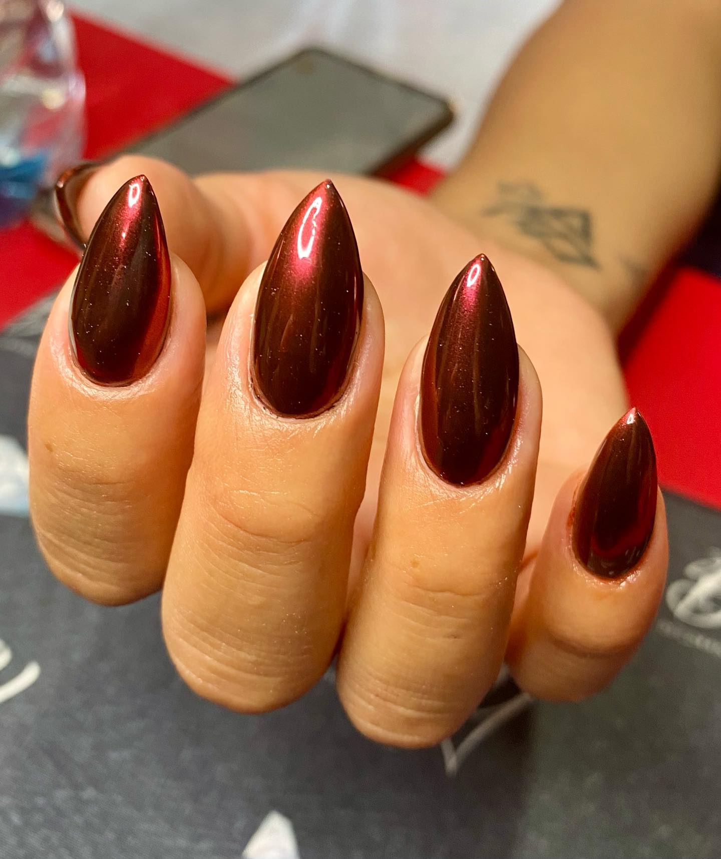 Metallic burgundy is not a popular choice but can you see how nice it looks on these stiletto nails?