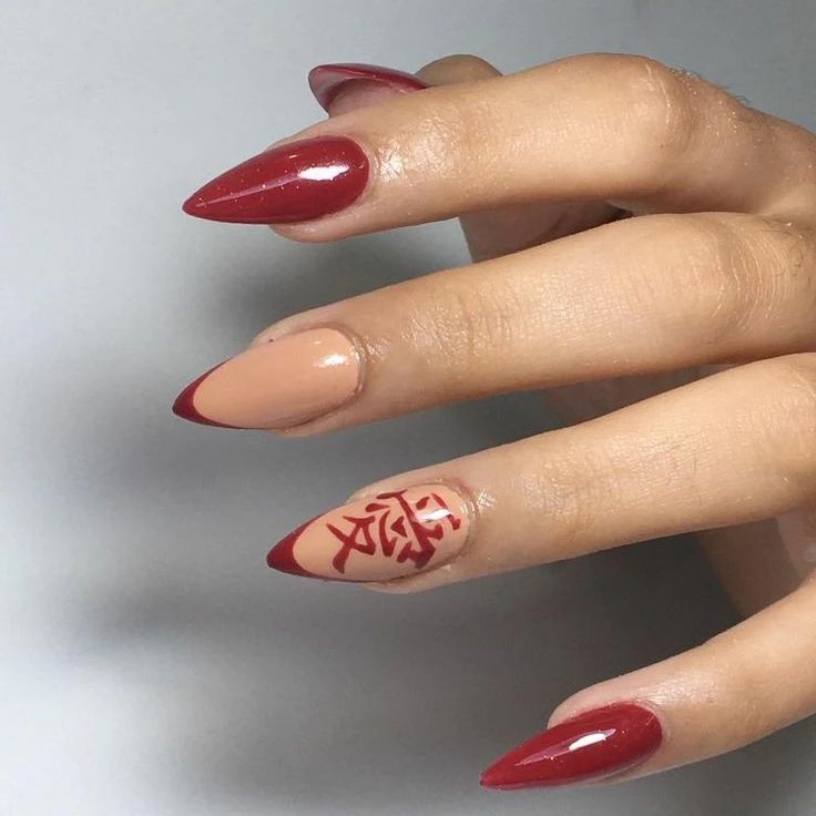 Here is a medium length stiletto nails. Red nail polish looks like a great idea to be matched with nude one. As an accent nail, you can draw a Chinese character.