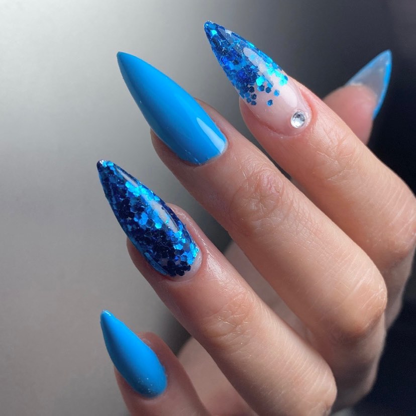 The color of freedom: Blue. This peaceful color will make you feel better with a stiletto mani. Glittered accent nails give a shiny look, too.