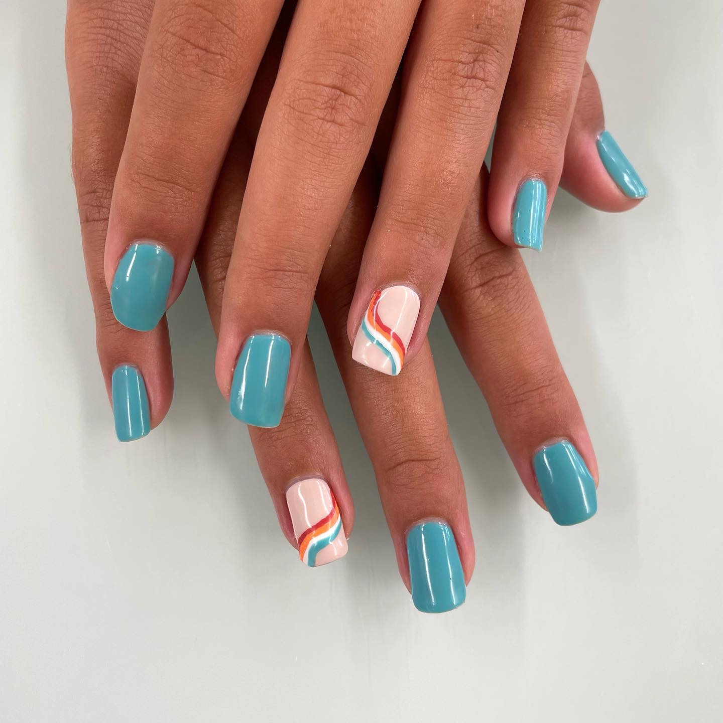  If you love blue but less shinier hue of it, this nail design is a great choice for you. For your accent nails, you can draw random swirls on top of a pastel pink base.