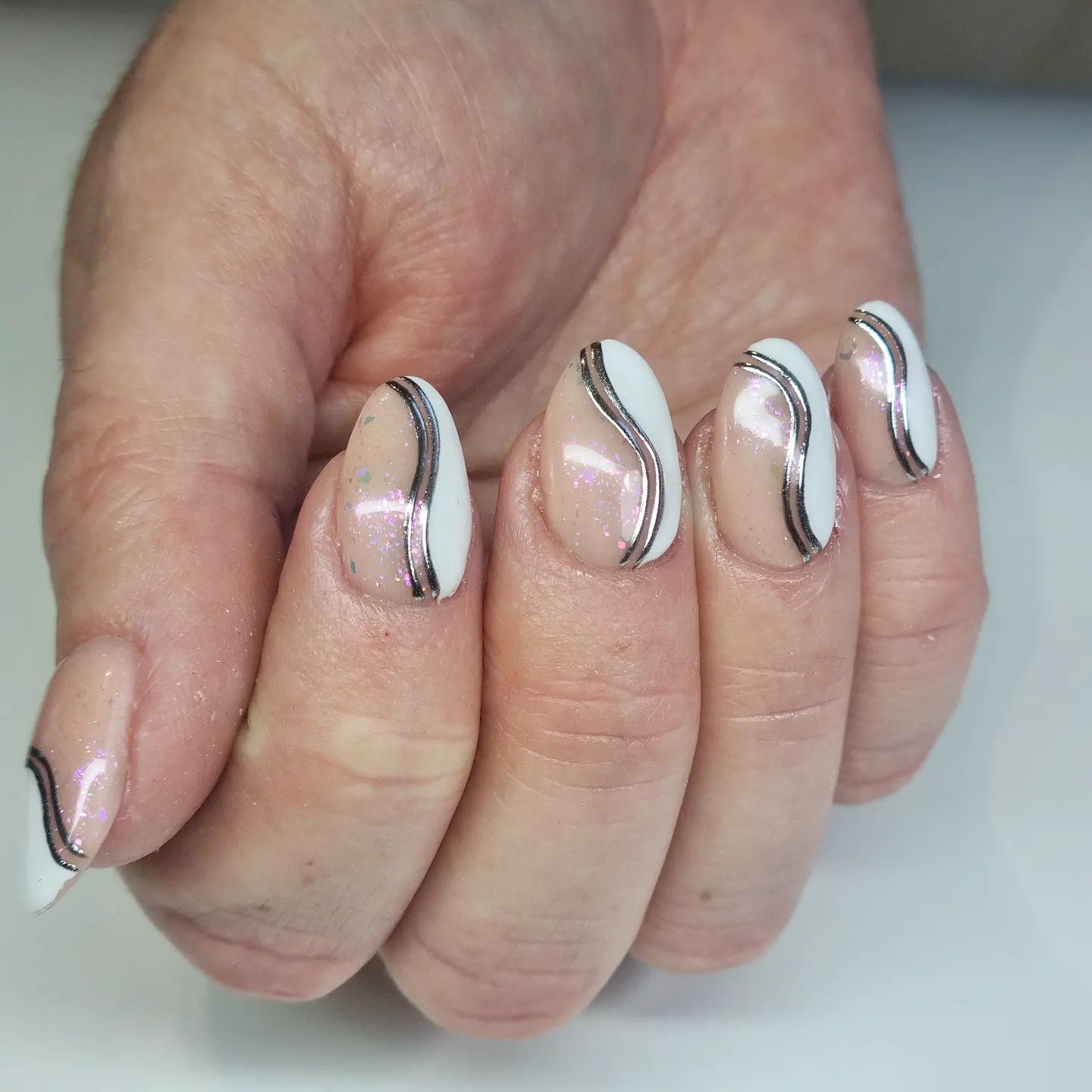 Thin swirl nail art is nice but sometimes thick ones are also classy. If you want to have swirls on each finger, these big swirls are preferable with a metallic look.