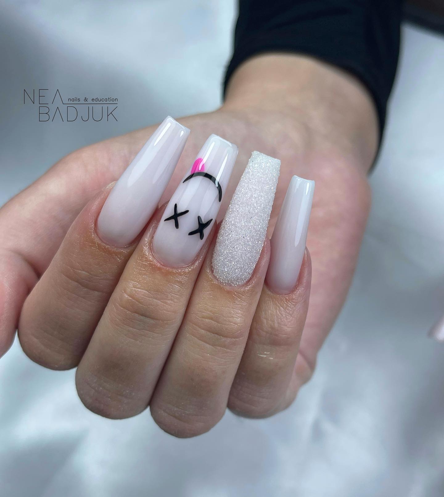 White is such a pure color that it turns every nail into an art piece. To show your personality and change its energy, you can have a glittered white accent nail with a smiley face. It will look fun and creative at the same time!