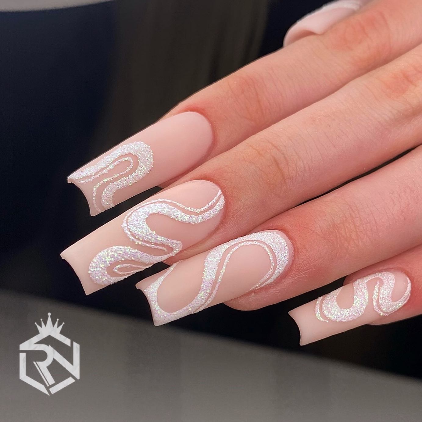 Shiny white swirl nails are such a fun and easy way to add some color and sparkle to your nude matte nail polish. They can be suitable for your wedding day or any special event.