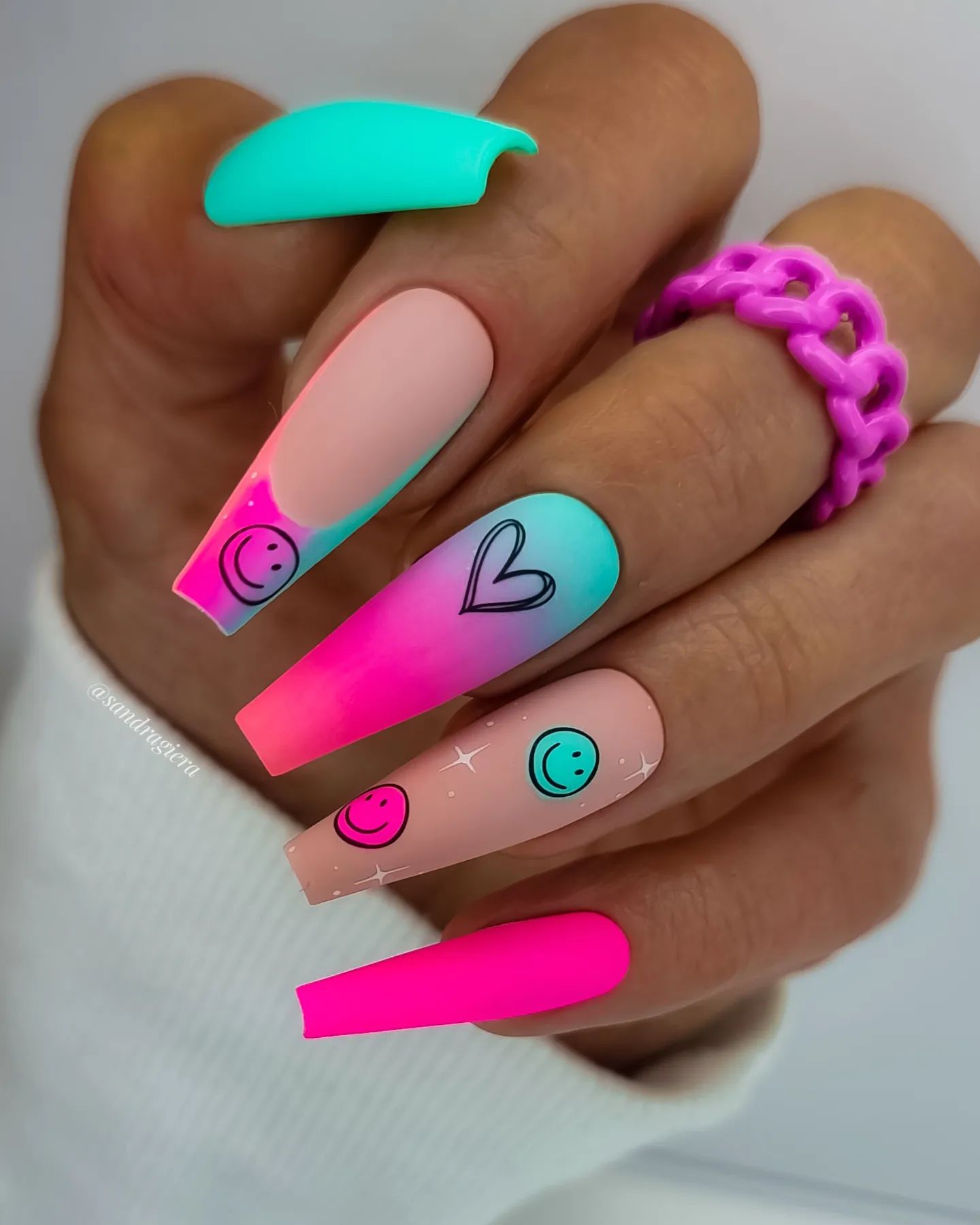 Turquoise and pink colors are so bright, and the pink is a great contrast to the turquoise. Three different nail designs are used such as French mani, ombre and smiley face nails. This nail style is perfect for summer!