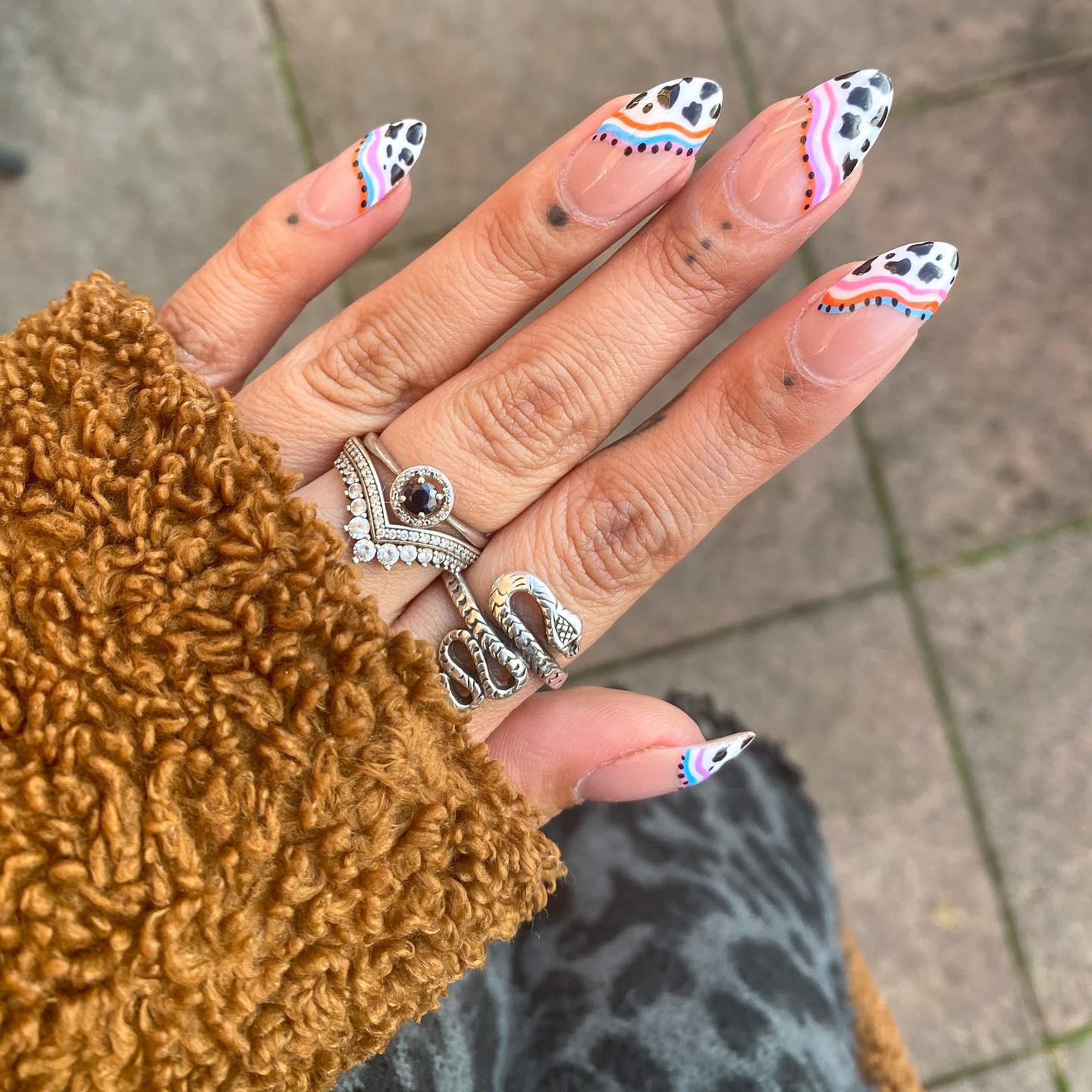 A little bit of colorful swirls and cow print French tips are all you need to feel like a nail art queen! You should get this mani as soon as possible.