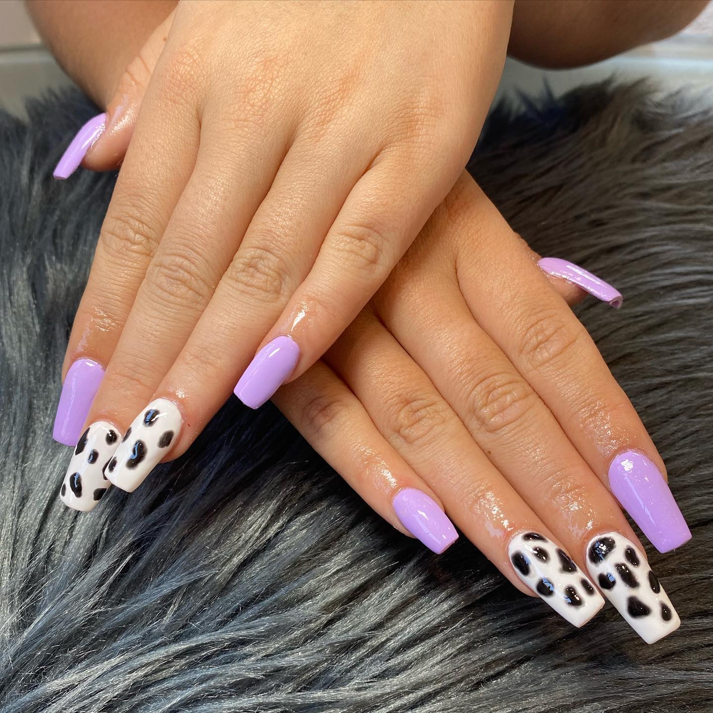 Cow print with lilac nail polish is a great combo. The contrast of the two colors is really fun, and it looks like you're wearing a cow on your nails.