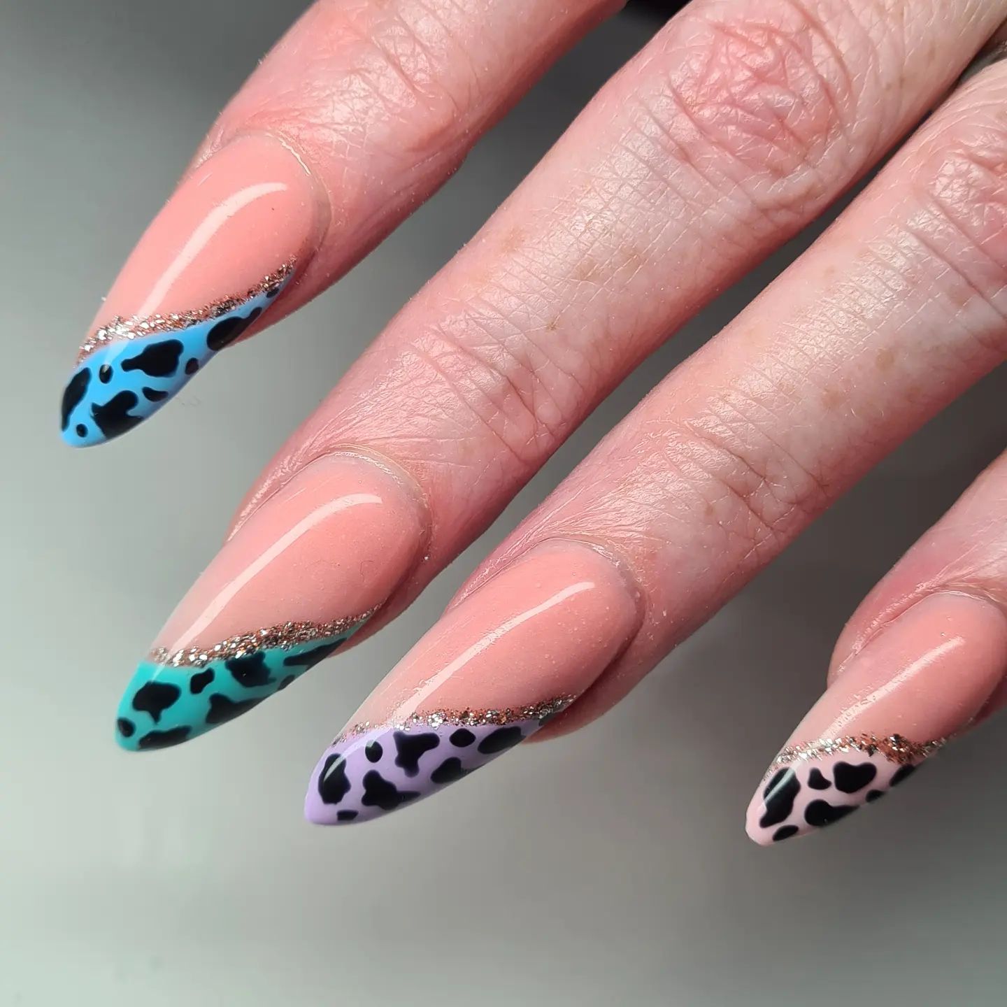 Covering all of your nails with cow prints may sound boring to you, so we have a great example to try. First, apply nude nail polish and add a swirl to each of your nails. The other part of the swirls will be covered with colorful cow prints and you will look amazing with them!