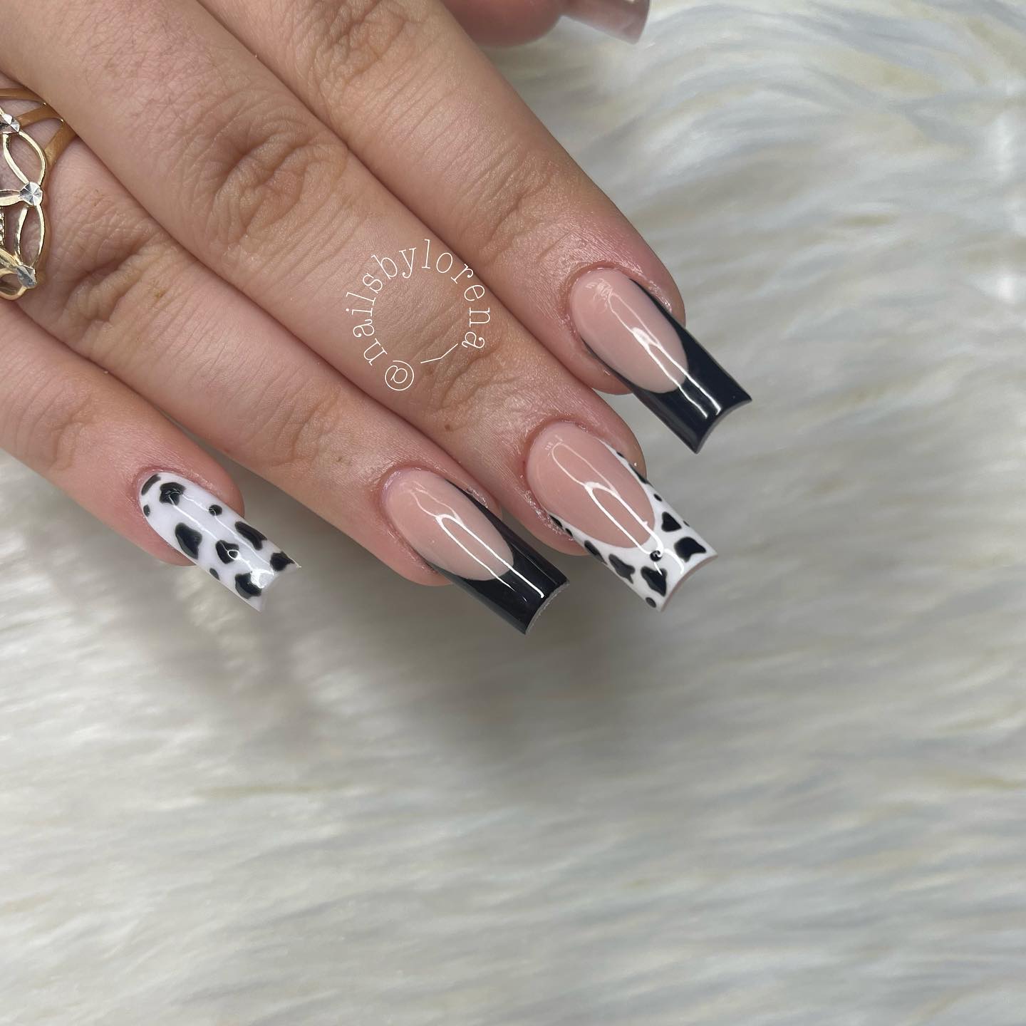Long an square manicure is best combined with French tips. Typical white French tips are sometimes boring, so why don't go for cow print and black tips?