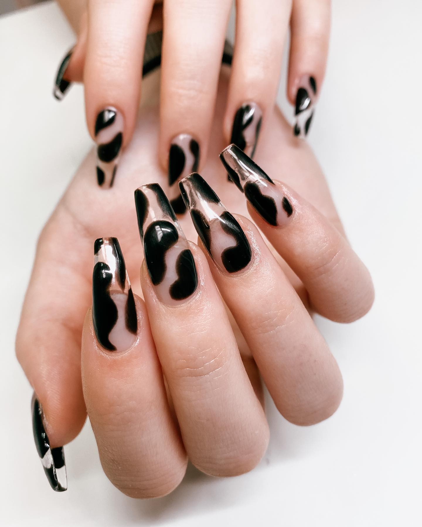 Long ballerina gel nails are the best manicure because they last a long time and are shiny. If you wanna achieve an elegant look, you can apply some random black cow prints on your transparent gel nails.