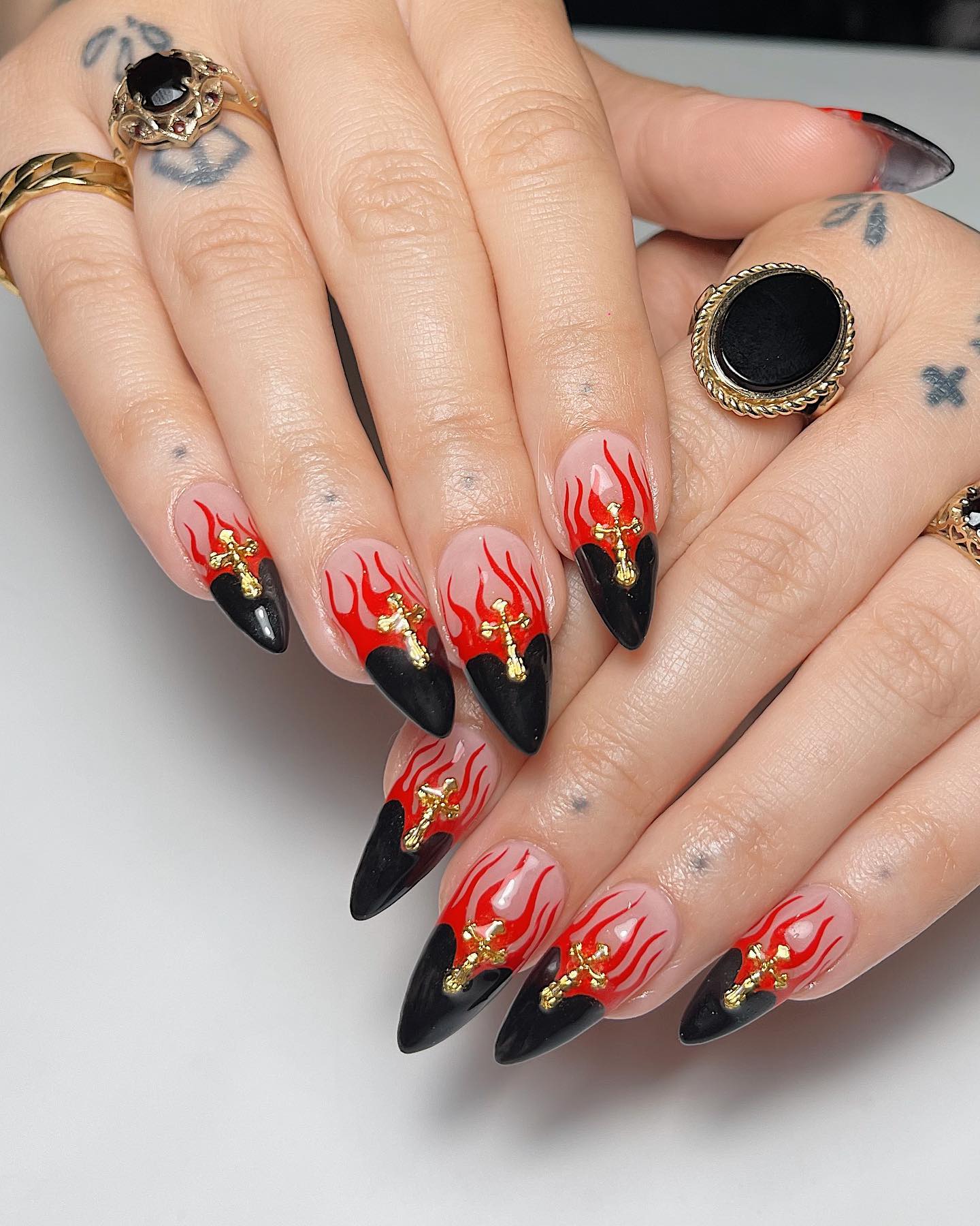 Red and black color combo works so well on nails like the one above. Black French tips and red flames can make you stand out from the crowd. Plus, if you are a religious person, adding a silver cross is a nice way to show your love to your religion.